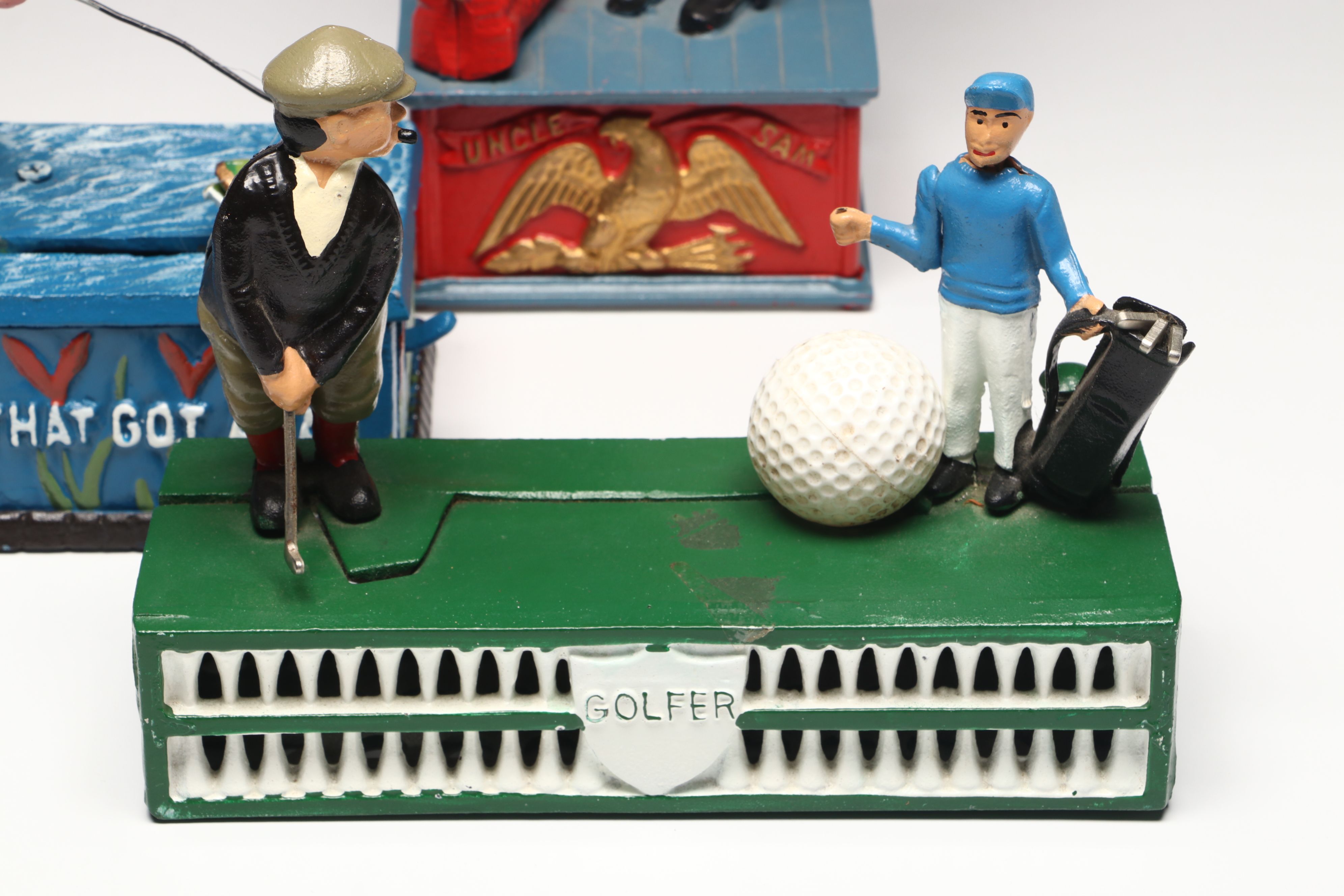 Reproduction Cold-Painted Cast Iron Uncle Sam, Golfer and Fishing Coin Banks