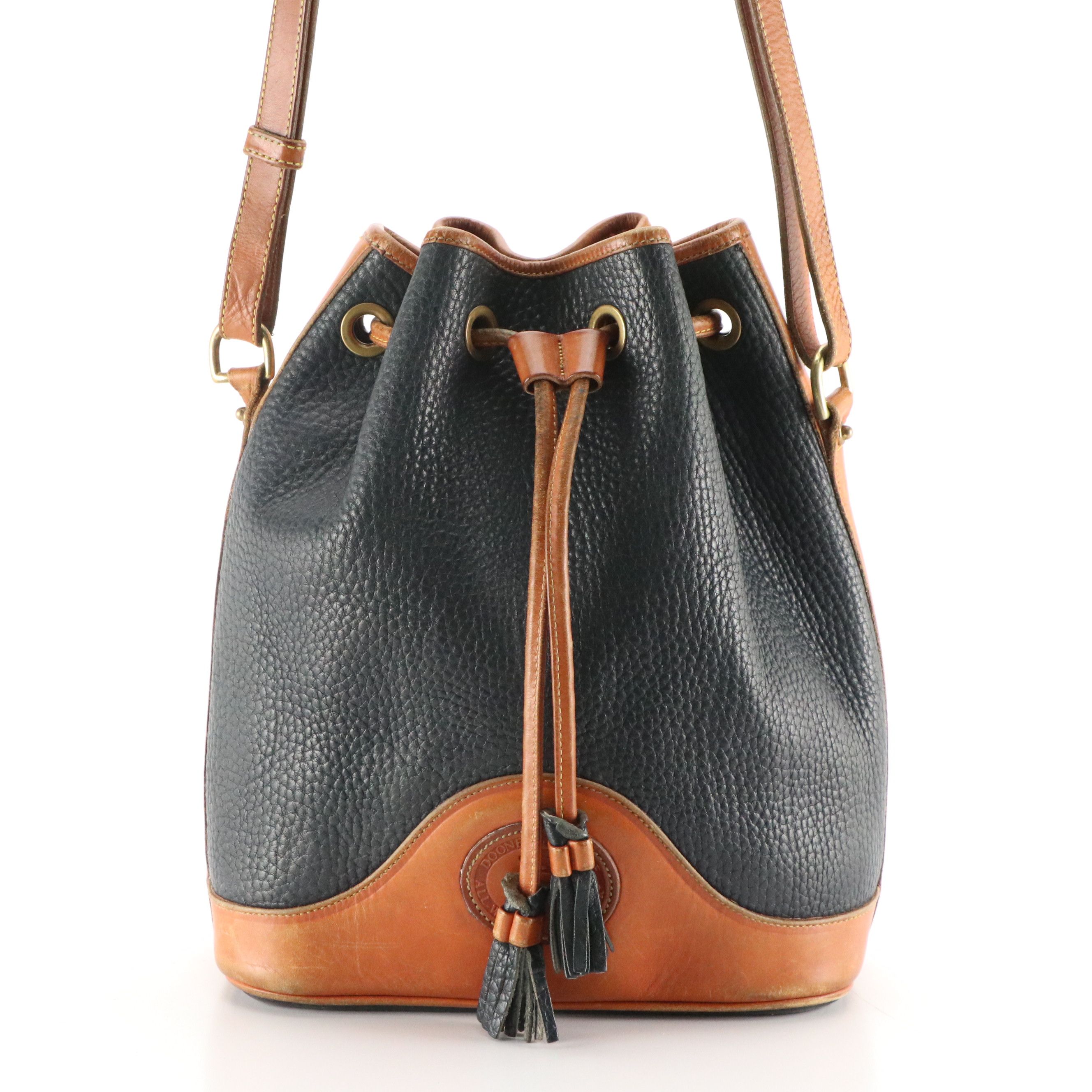 Dooney & Bourke Drawstring Bucket Bag in Navy Blue All-Weather & Brown Leather