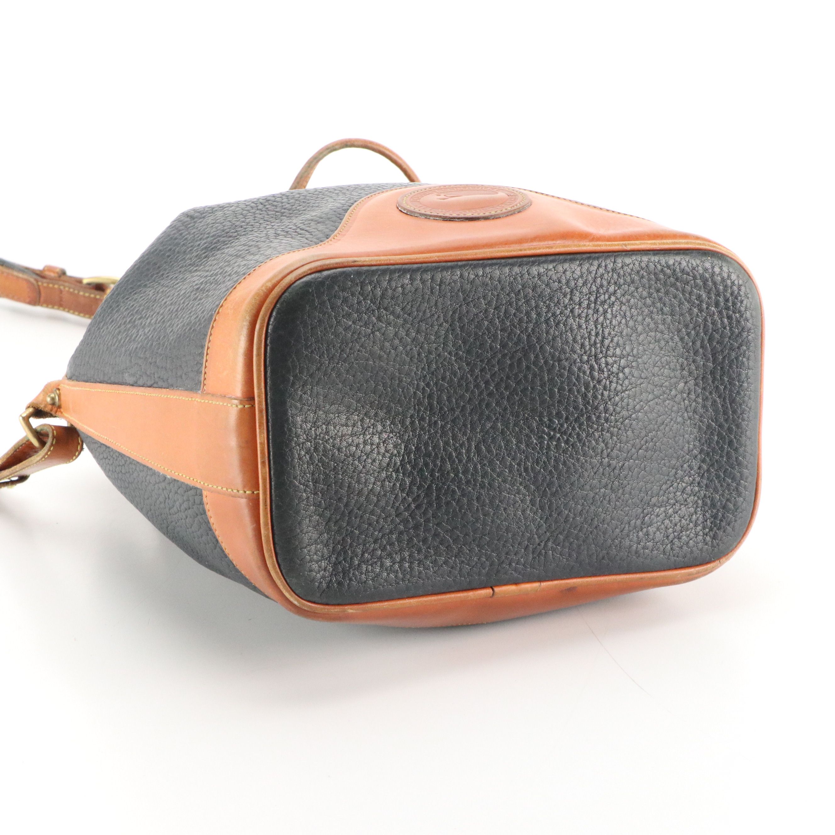 Dooney & Bourke Drawstring Bucket Bag in Navy Blue All-Weather & Brown Leather