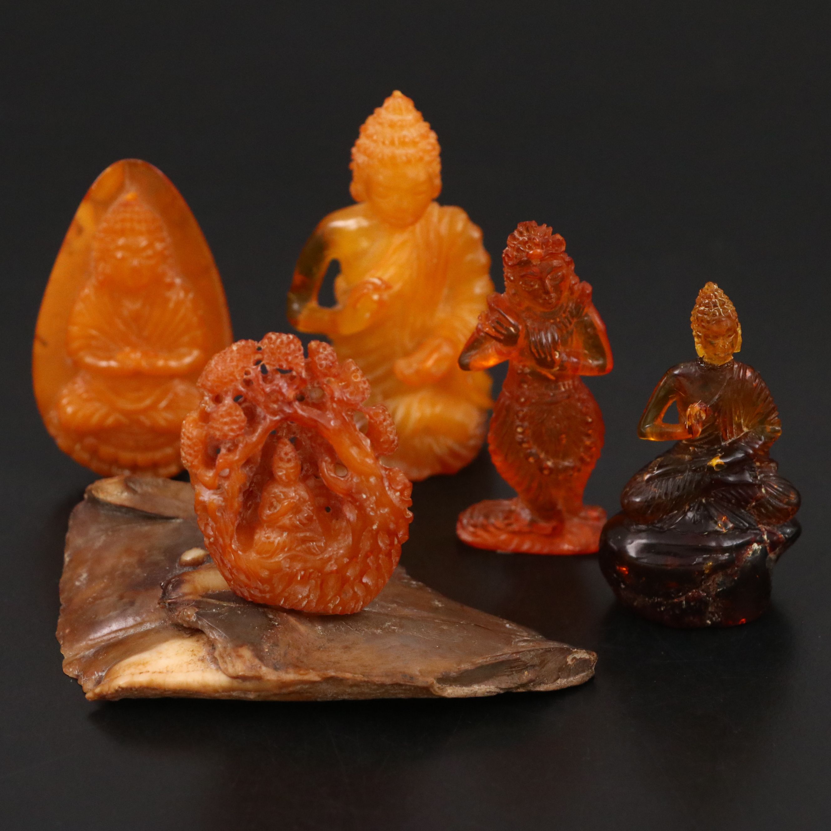 Chinese Mutton Fat Amber Seated Buddha with Other Amber Carvings