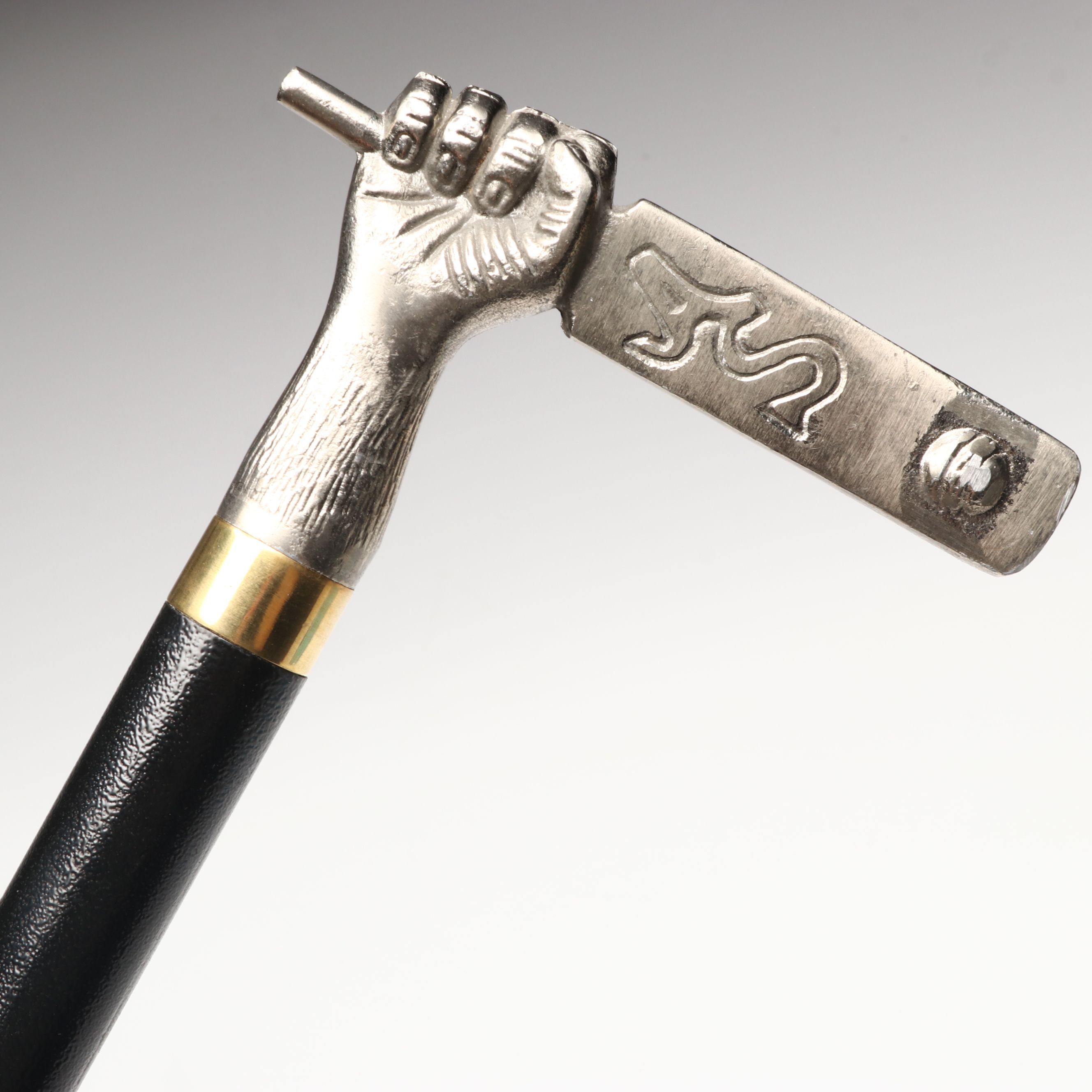 Hand Holding Paddle Handled Sword Cane