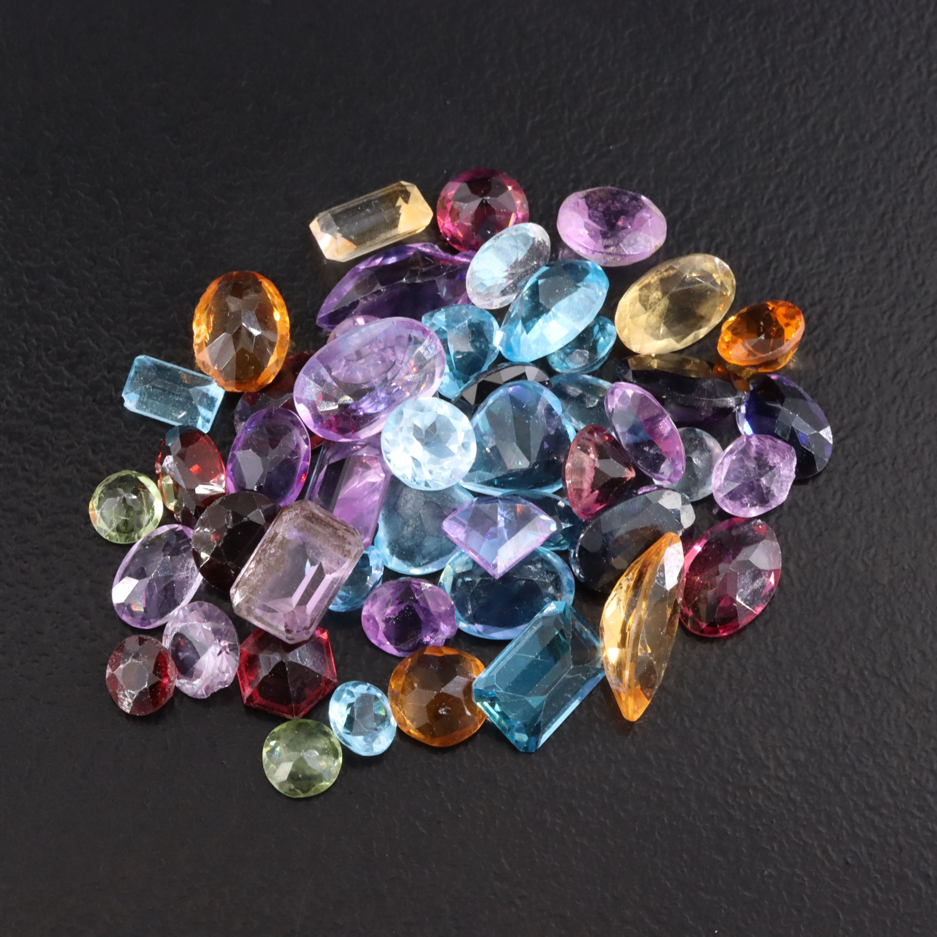 Loose 30.40 CTW Gemstone Lot Featuring Amethyst, Topaz, Citrine