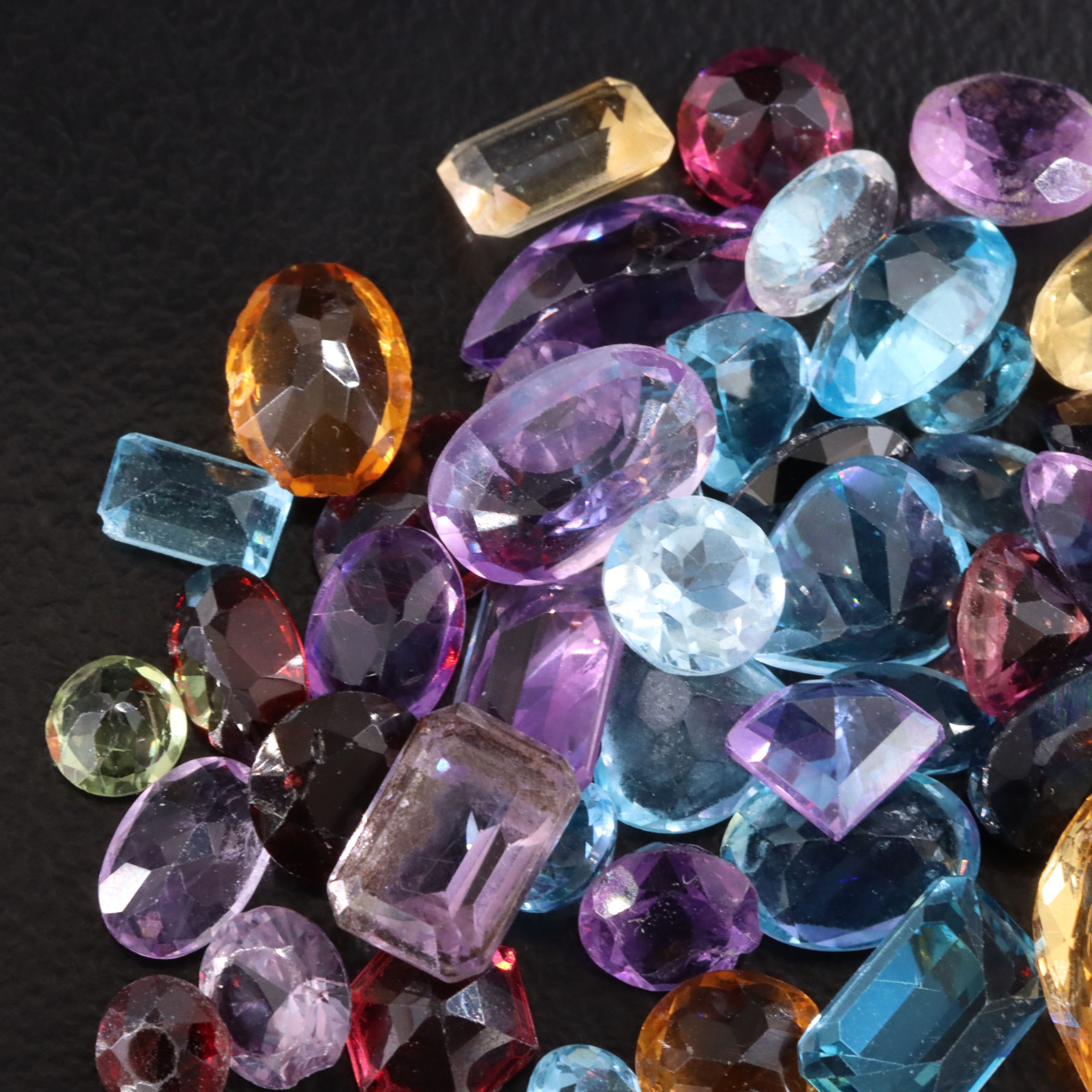 Loose 30.40 CTW Gemstone Lot Featuring Amethyst, Topaz, Citrine