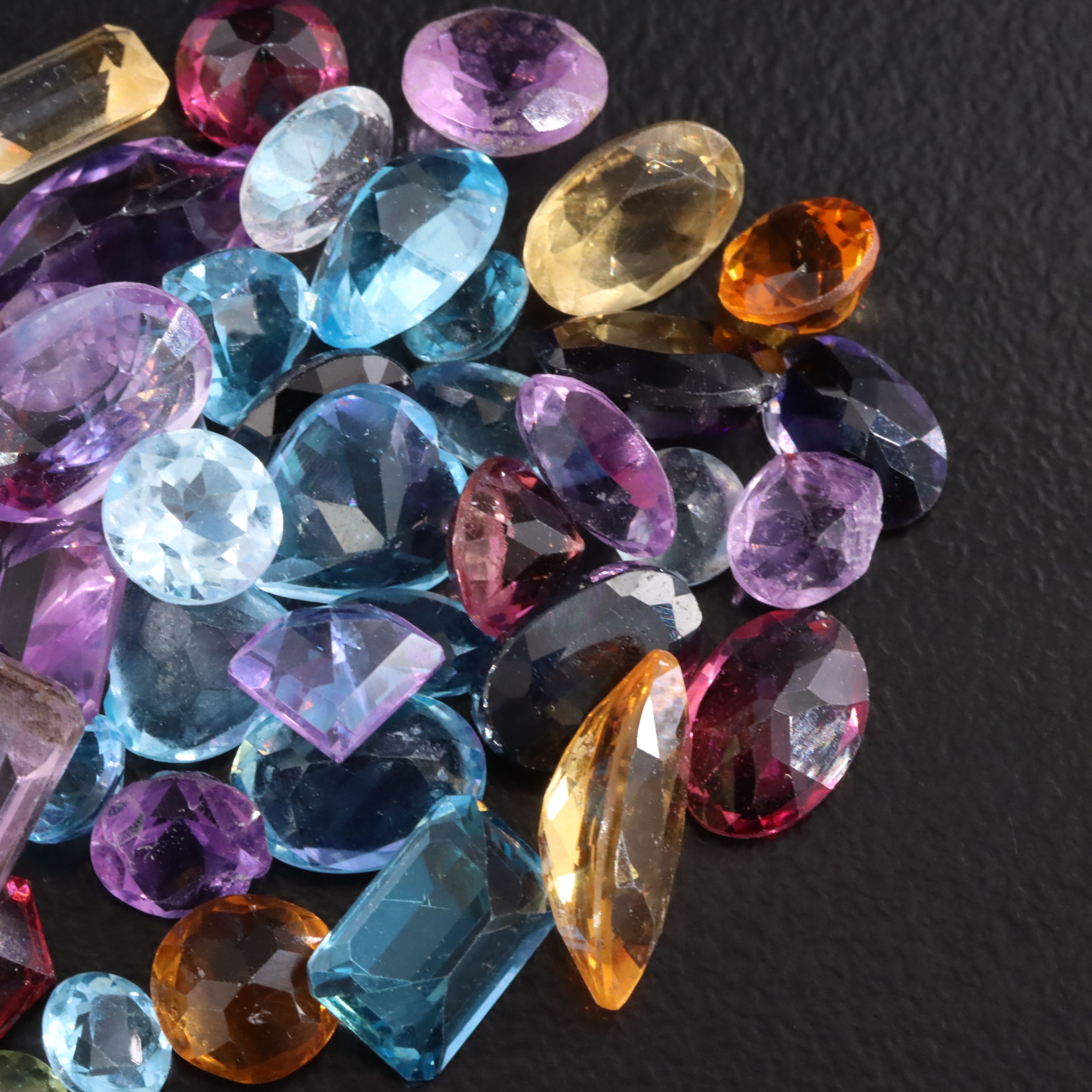 Loose 30.40 CTW Gemstone Lot Featuring Amethyst, Topaz, Citrine