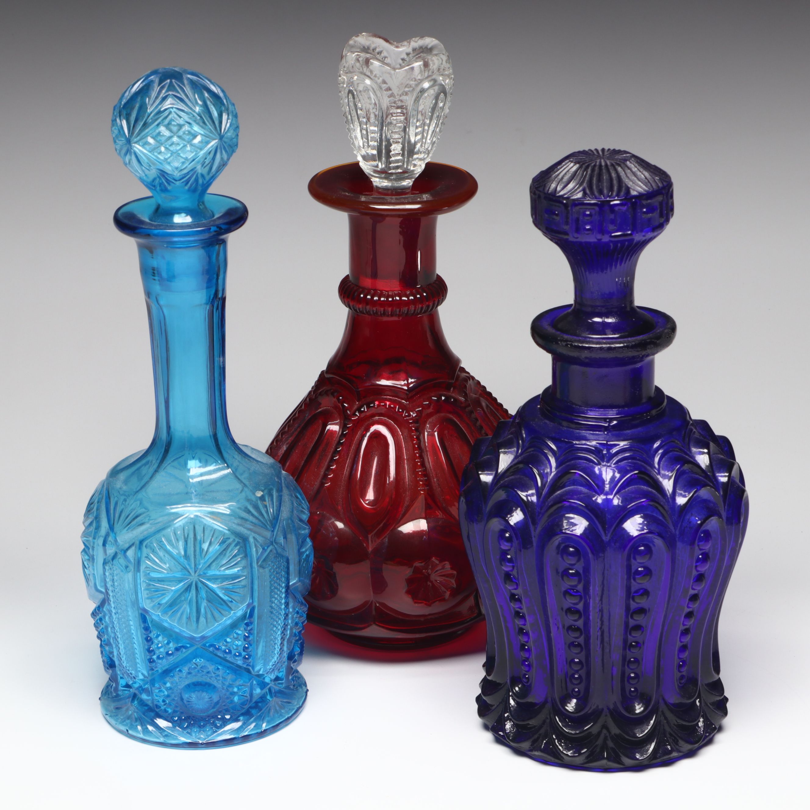 L. G. Wright "Moon and Star Ruby" Glass Decanter with Other Vintage Decanters