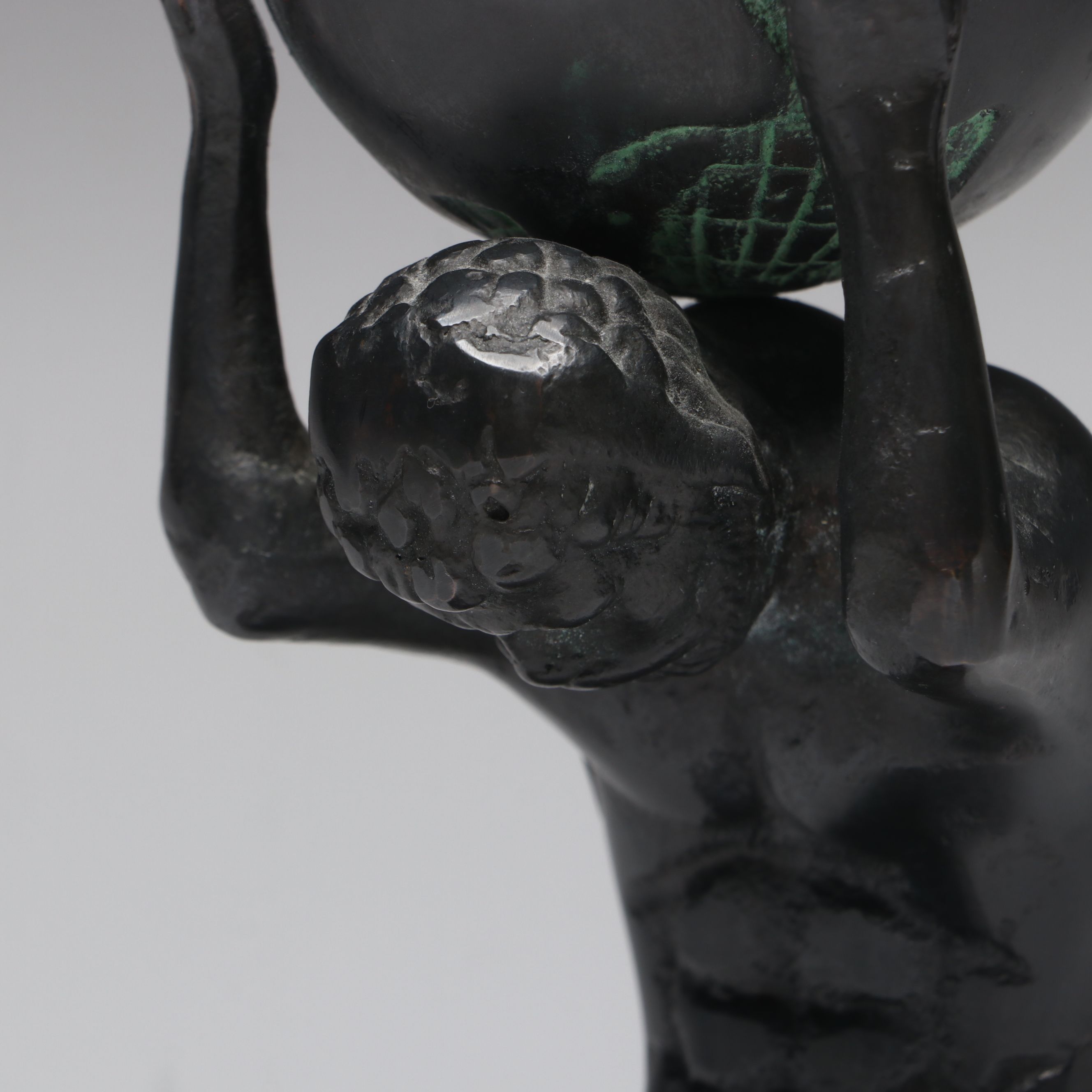 Metal Atlas Holding the World Bookends