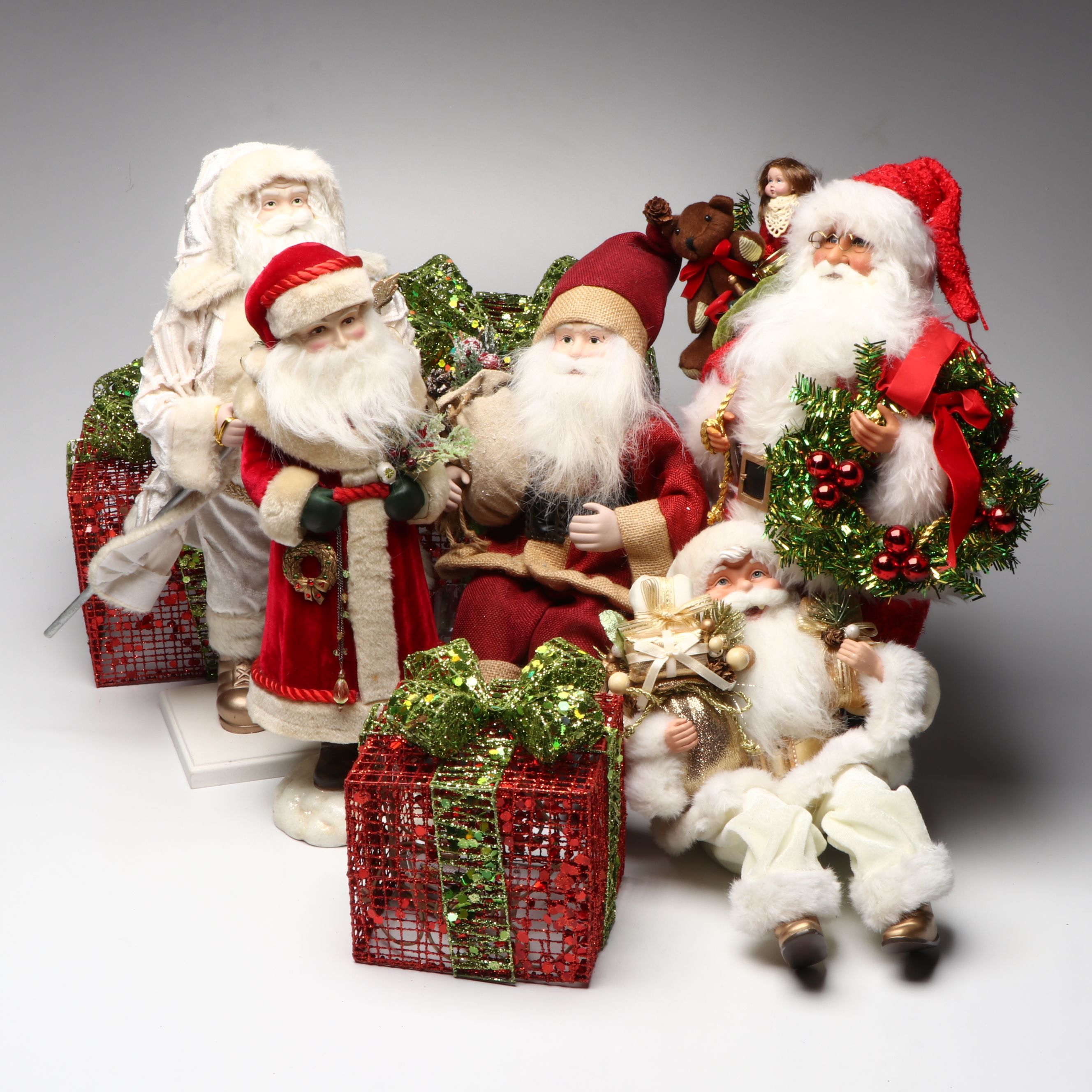 Karen Didion and Other Santa Figurines with Illuminated Gift Box Holiday Décor