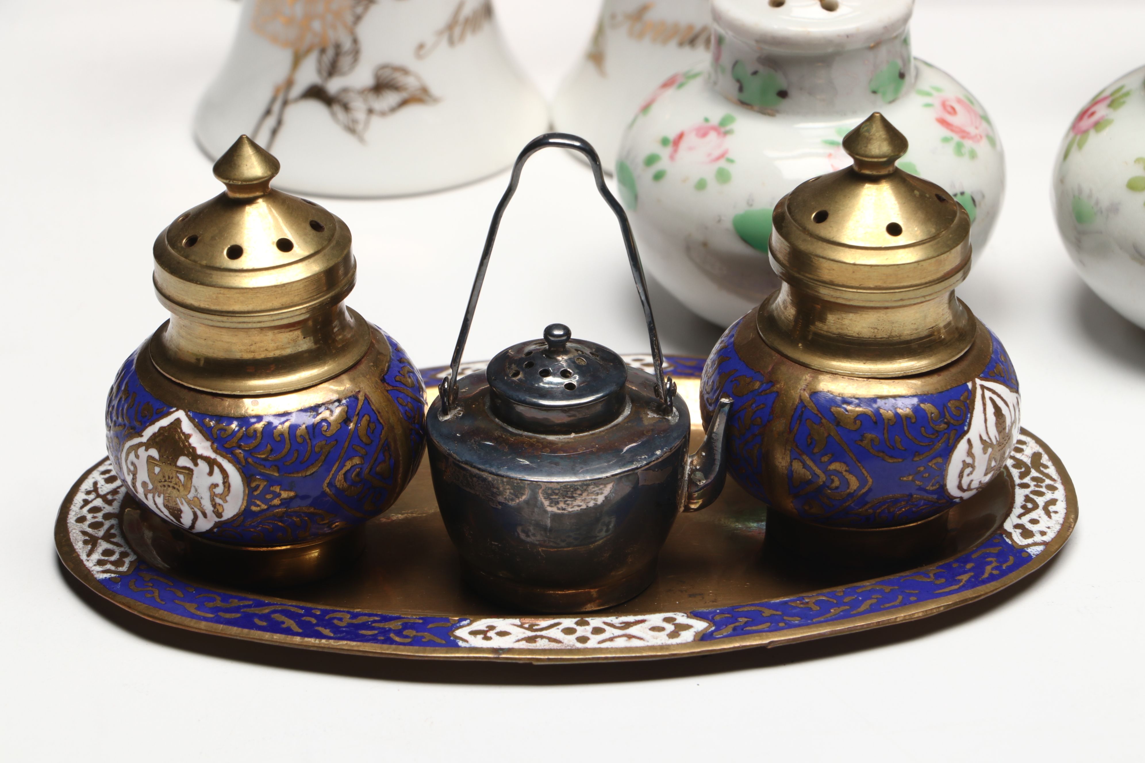 Collection of Glass, Porcelain, and More Shakers with Ceramic Table Trivet