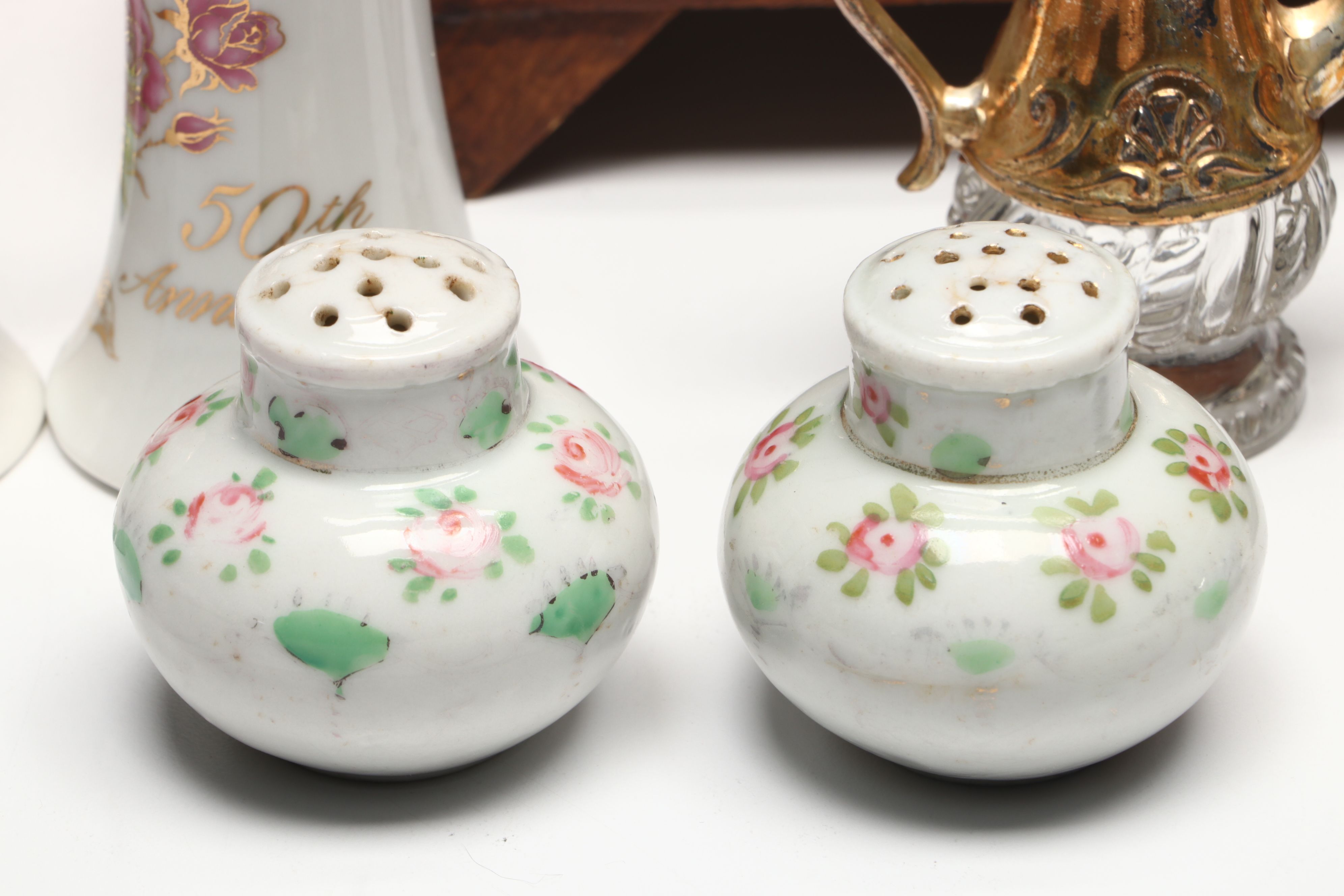 Collection of Glass, Porcelain, and More Shakers with Ceramic Table Trivet