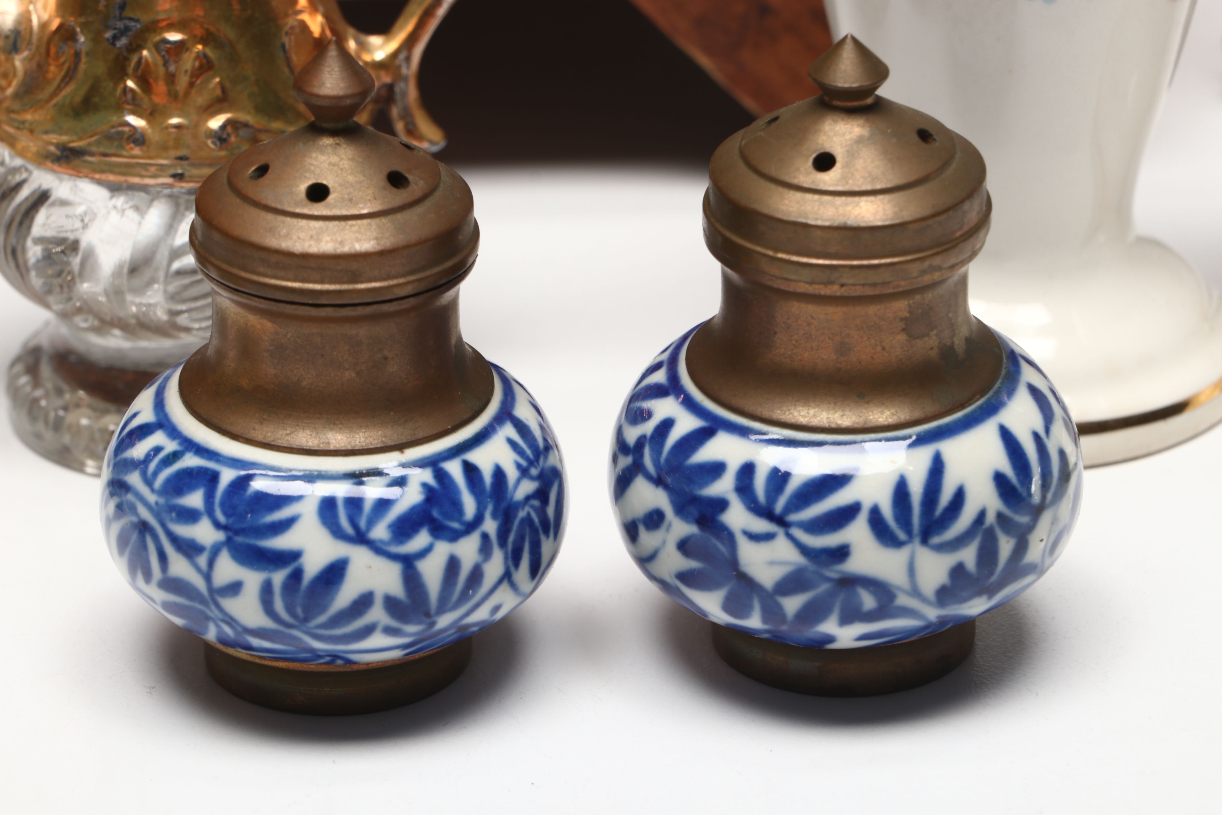 Collection of Glass, Porcelain, and More Shakers with Ceramic Table Trivet