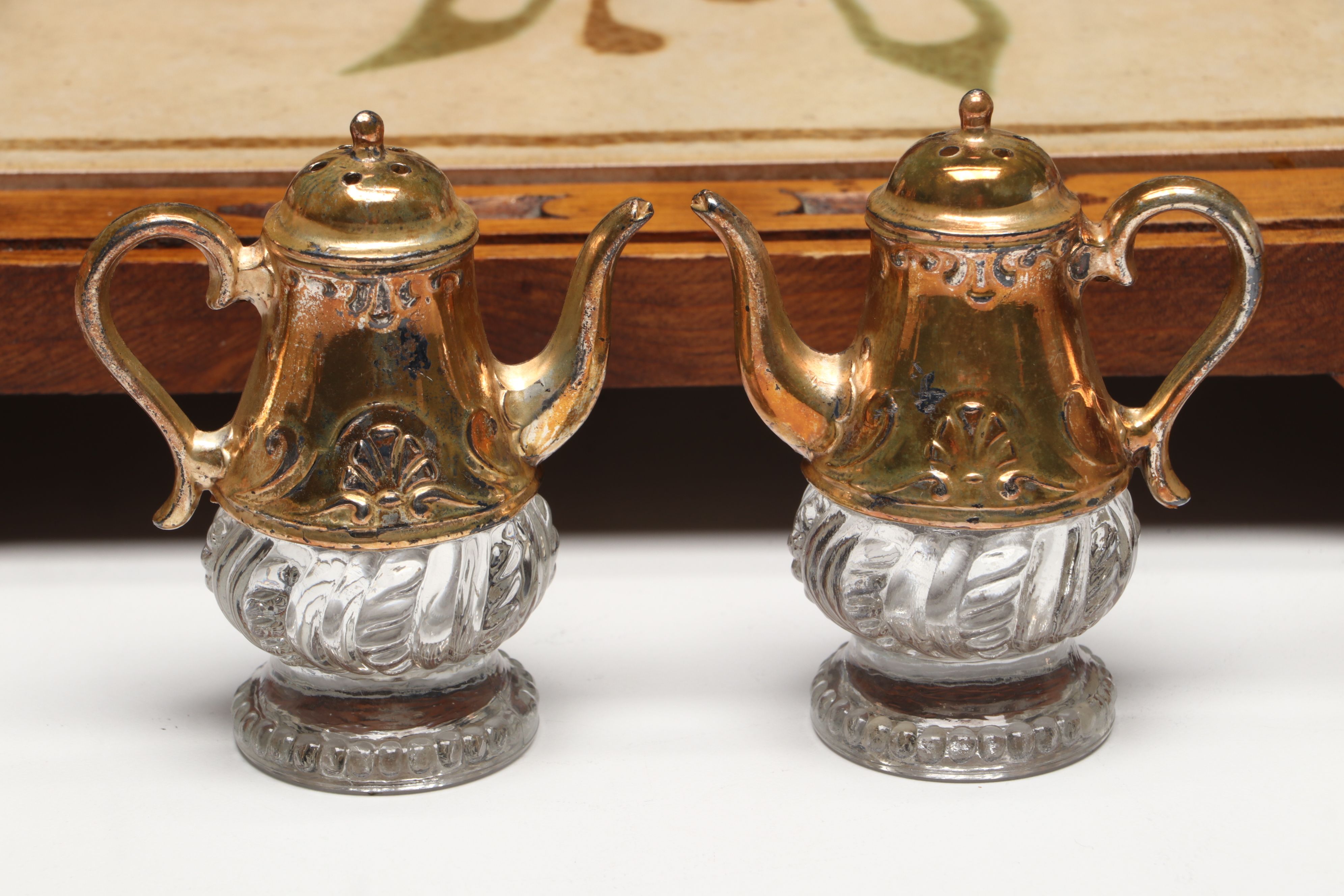 Collection of Glass, Porcelain, and More Shakers with Ceramic Table Trivet