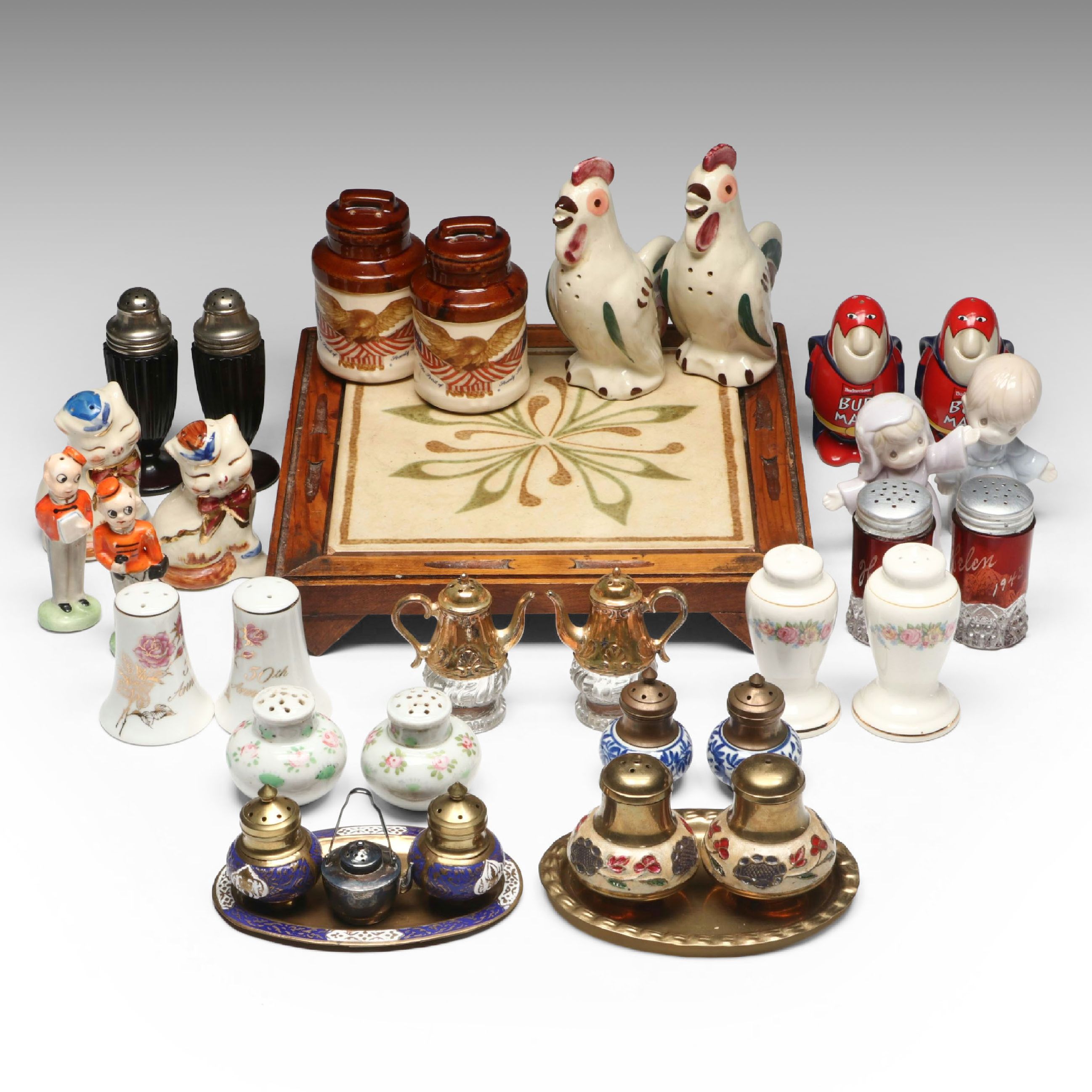 Collection of Glass, Porcelain, and More Shakers with Ceramic Table Trivet