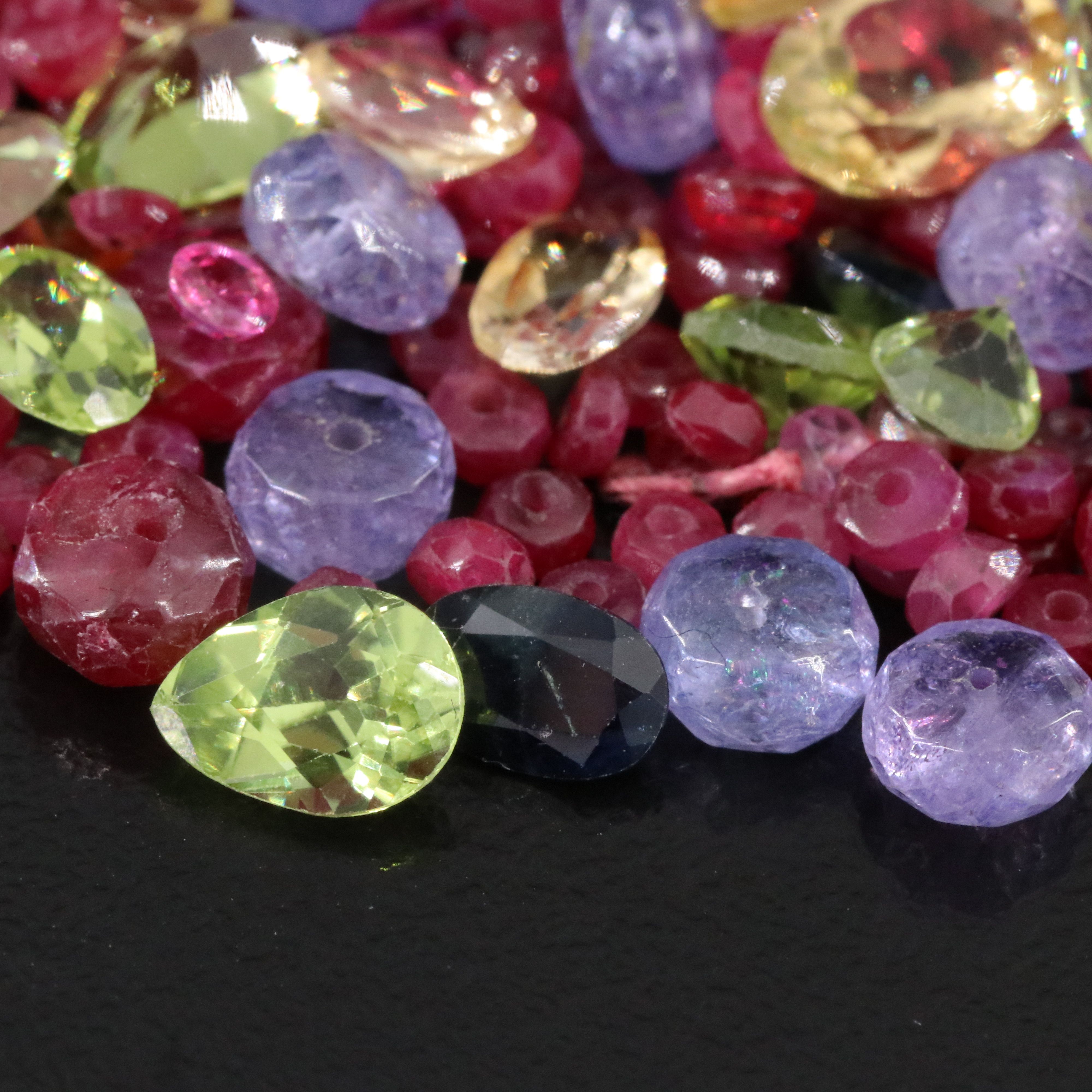 Loose 302.60 CTW Gemstone Lot Including Peridot, Tanzanite and Ruby