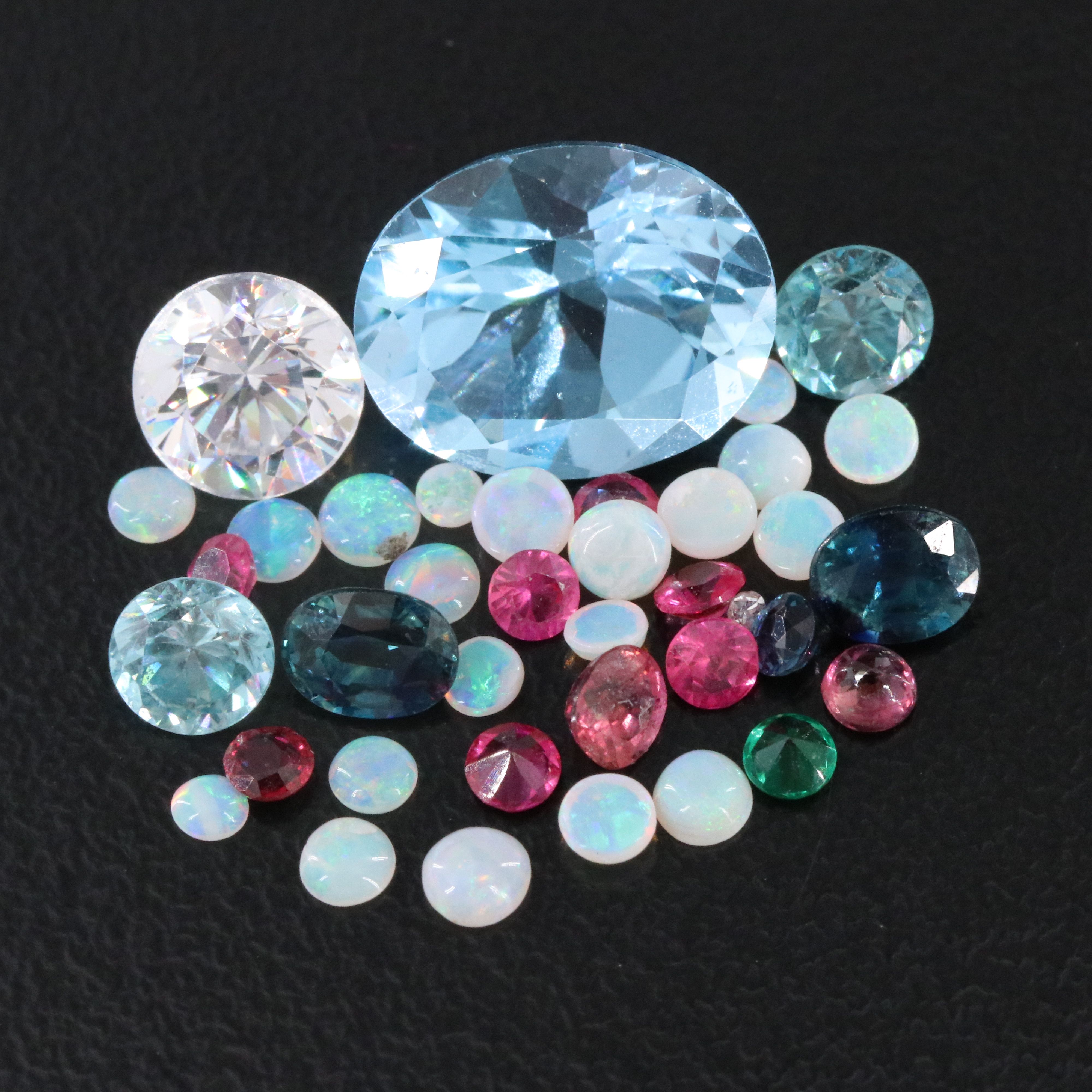 Loose 11.71 CTW Gemstone Lot Including Topaz, Ruby and Opal