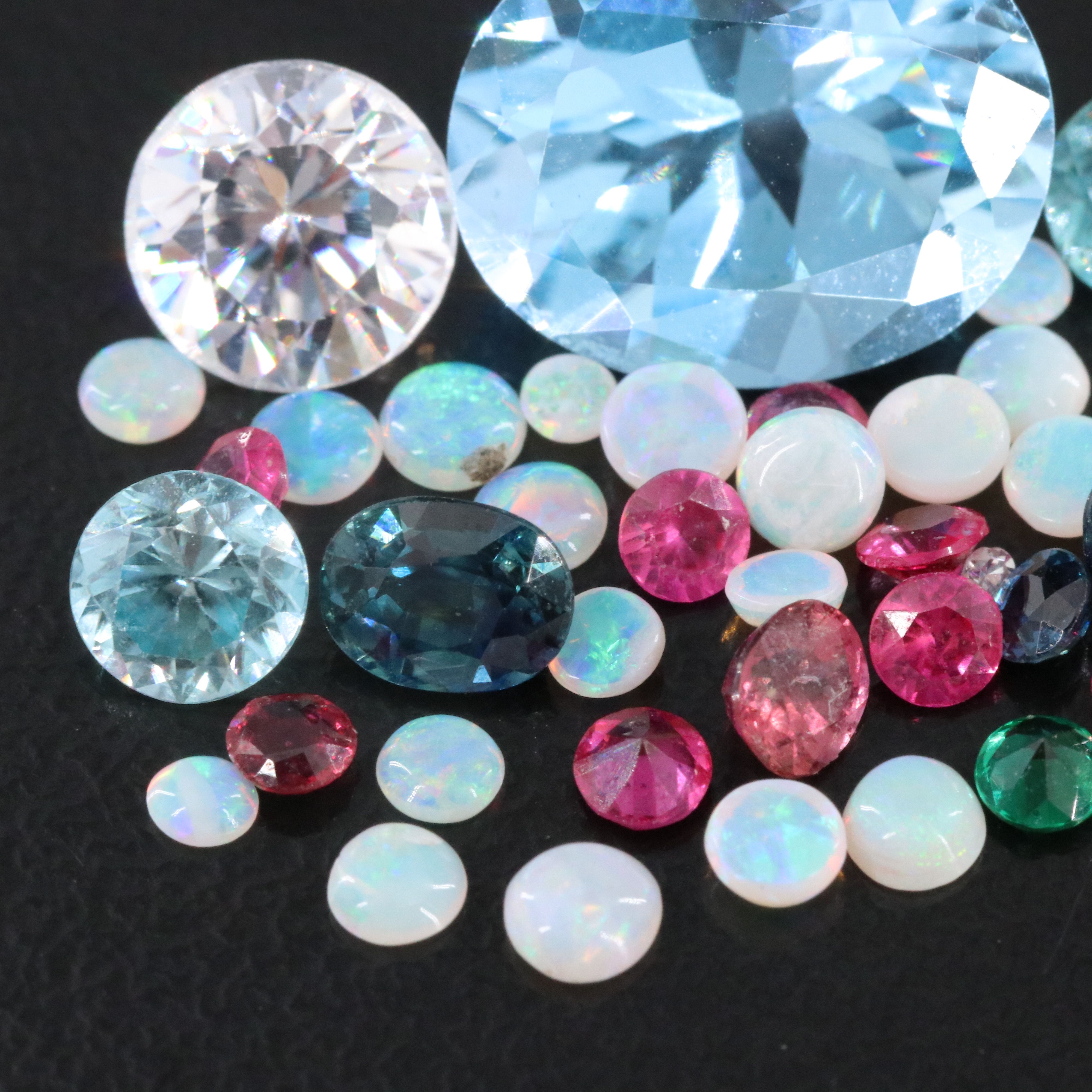 Loose 11.71 CTW Gemstone Lot Including Topaz, Ruby and Opal