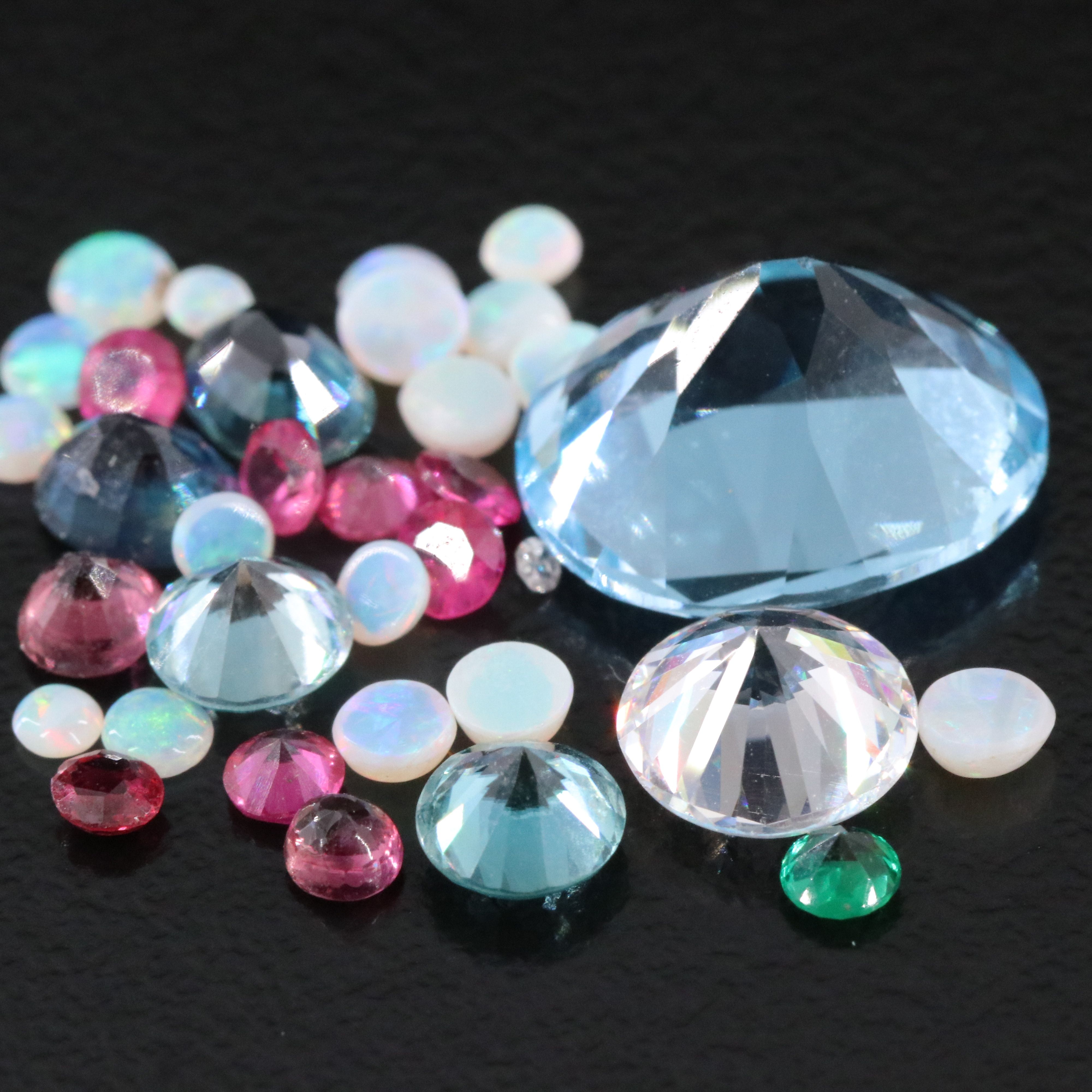 Loose 11.71 CTW Gemstone Lot Including Topaz, Ruby and Opal