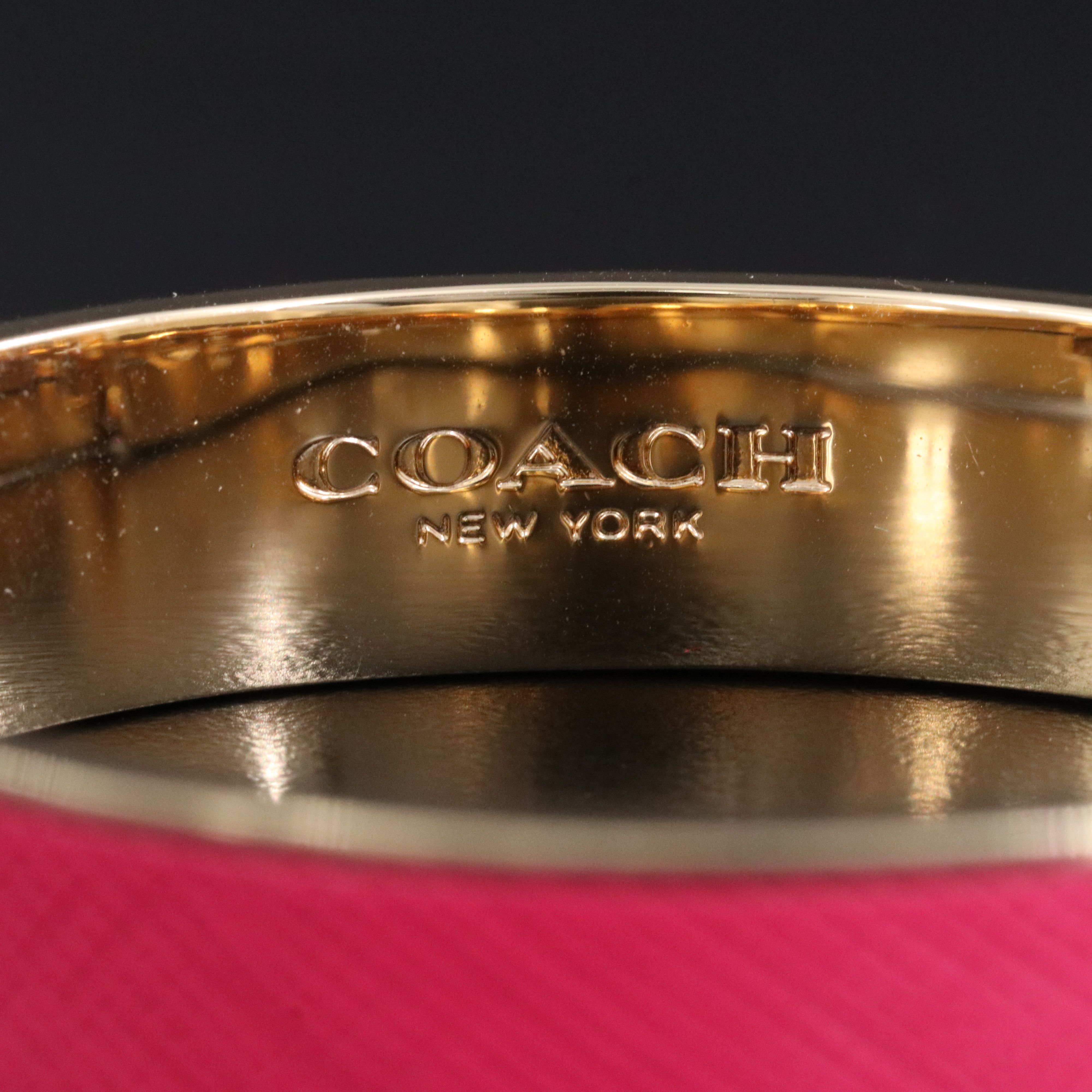 Coach textured pink latch bracelet