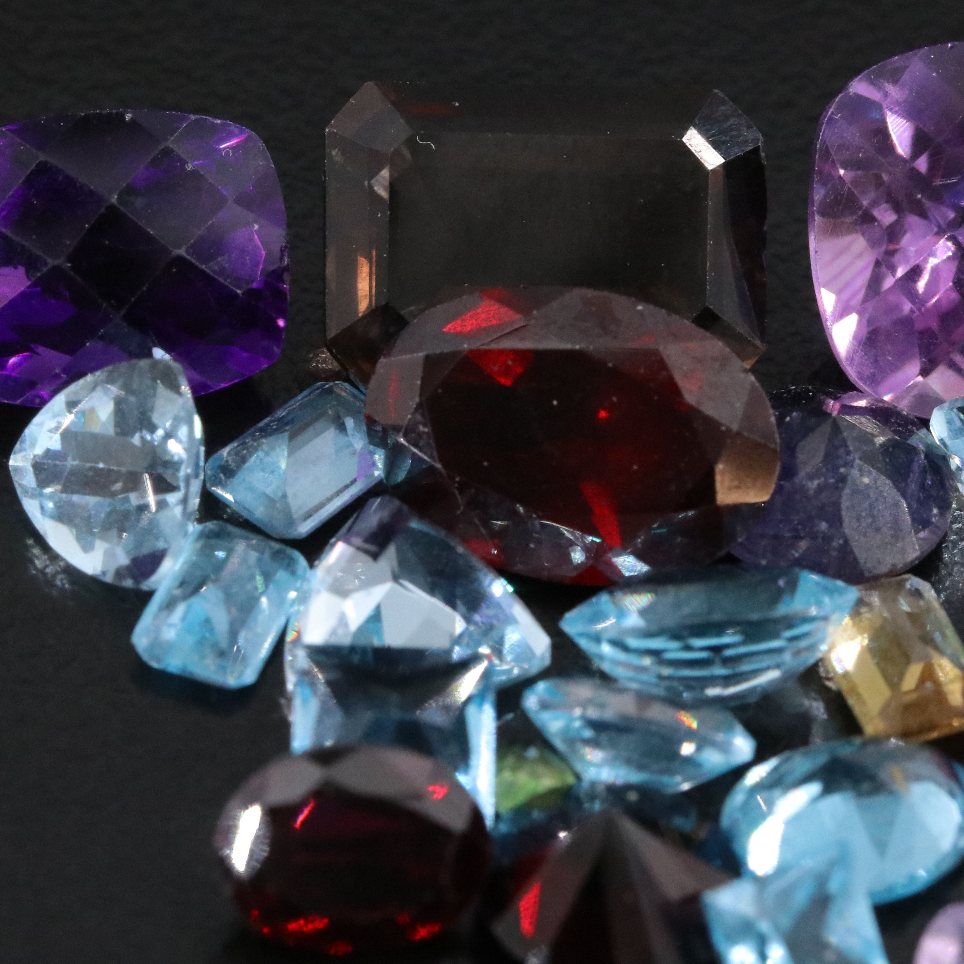 Loose 41.87 CTW Gemstone Lot Including Garnet, Topaz and Iolite