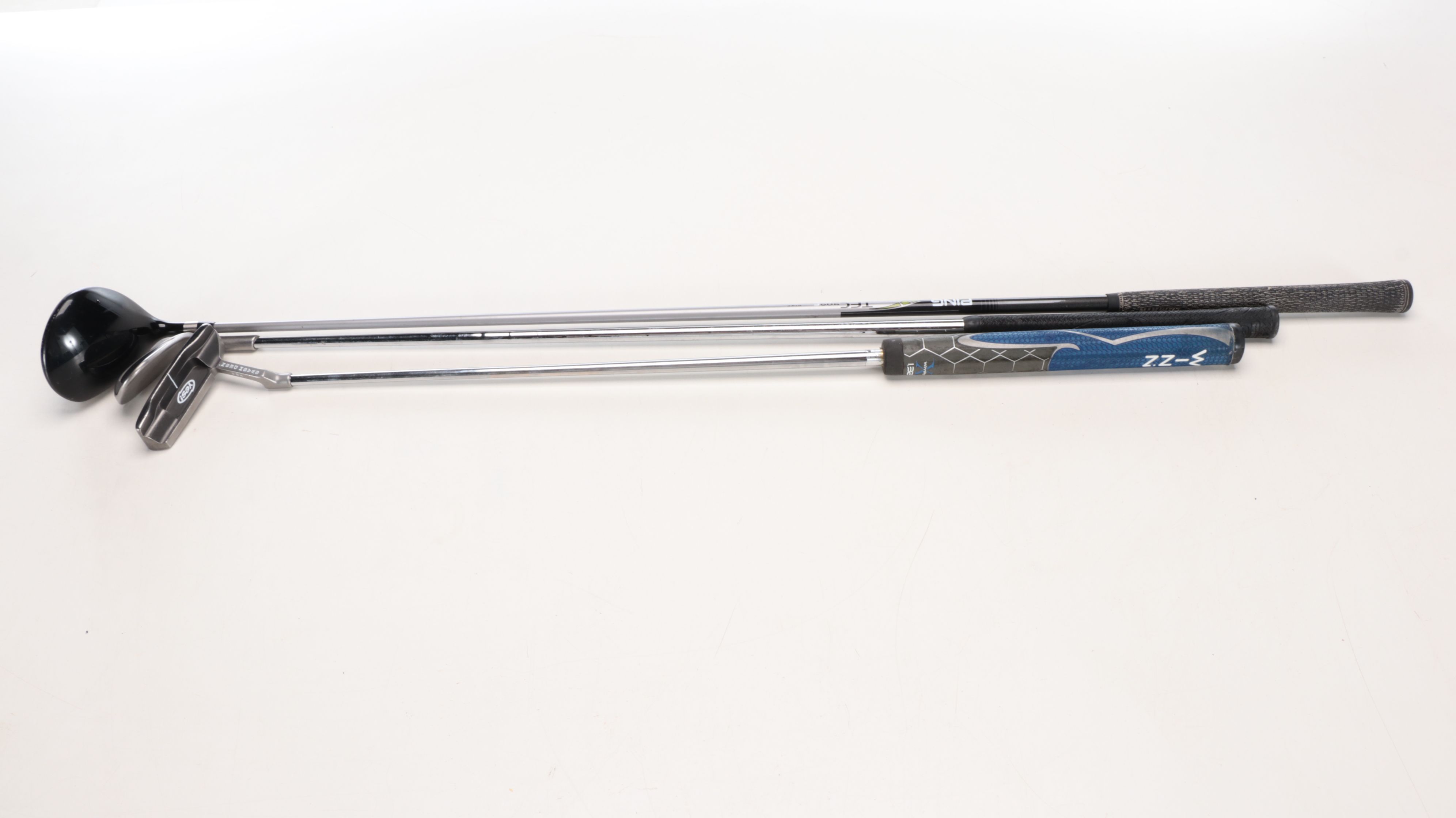 Karsten "Ping" Driver and Putters with Other Golf Clubs