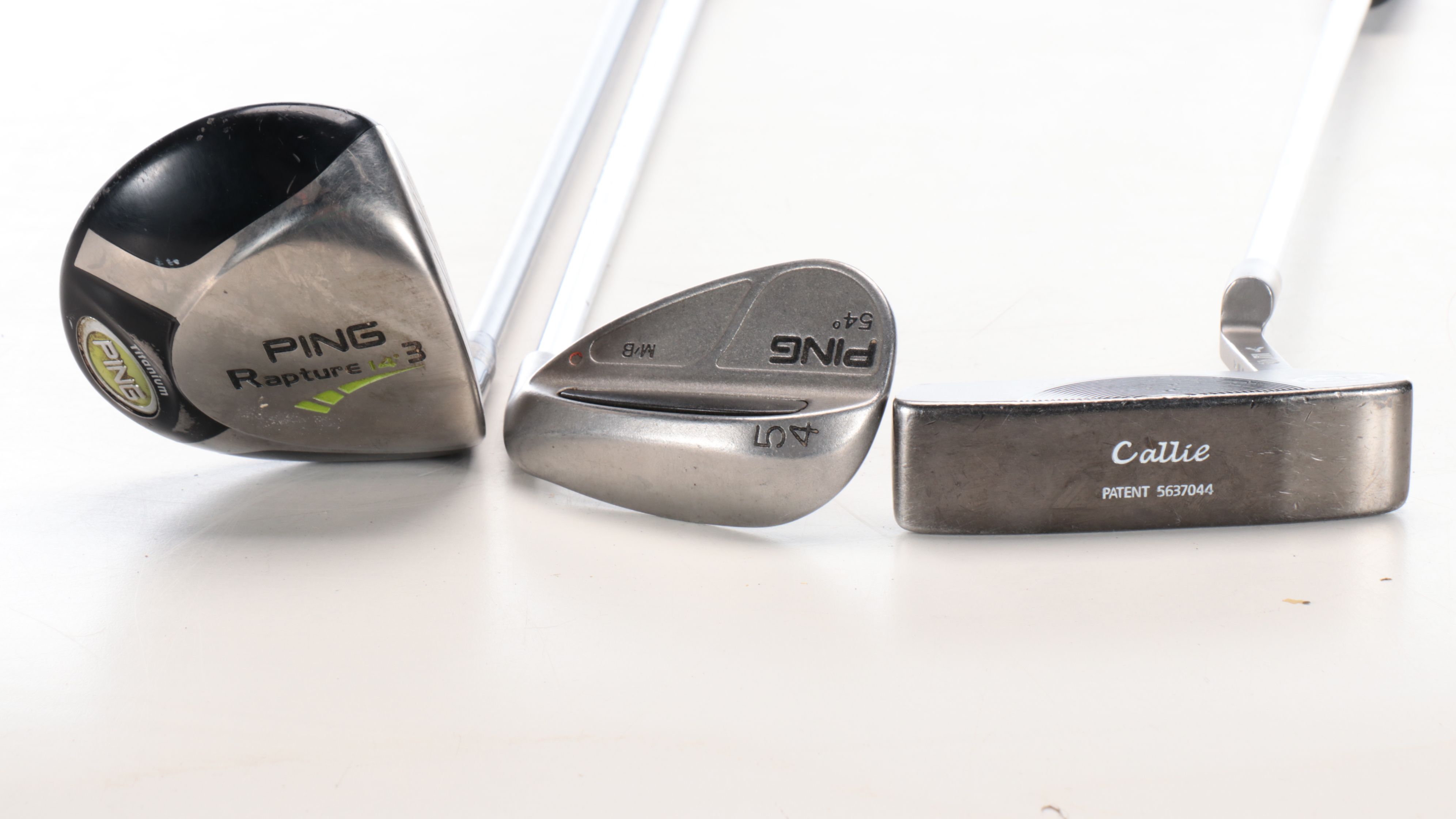 Karsten "Ping" Driver and Putters with Other Golf Clubs