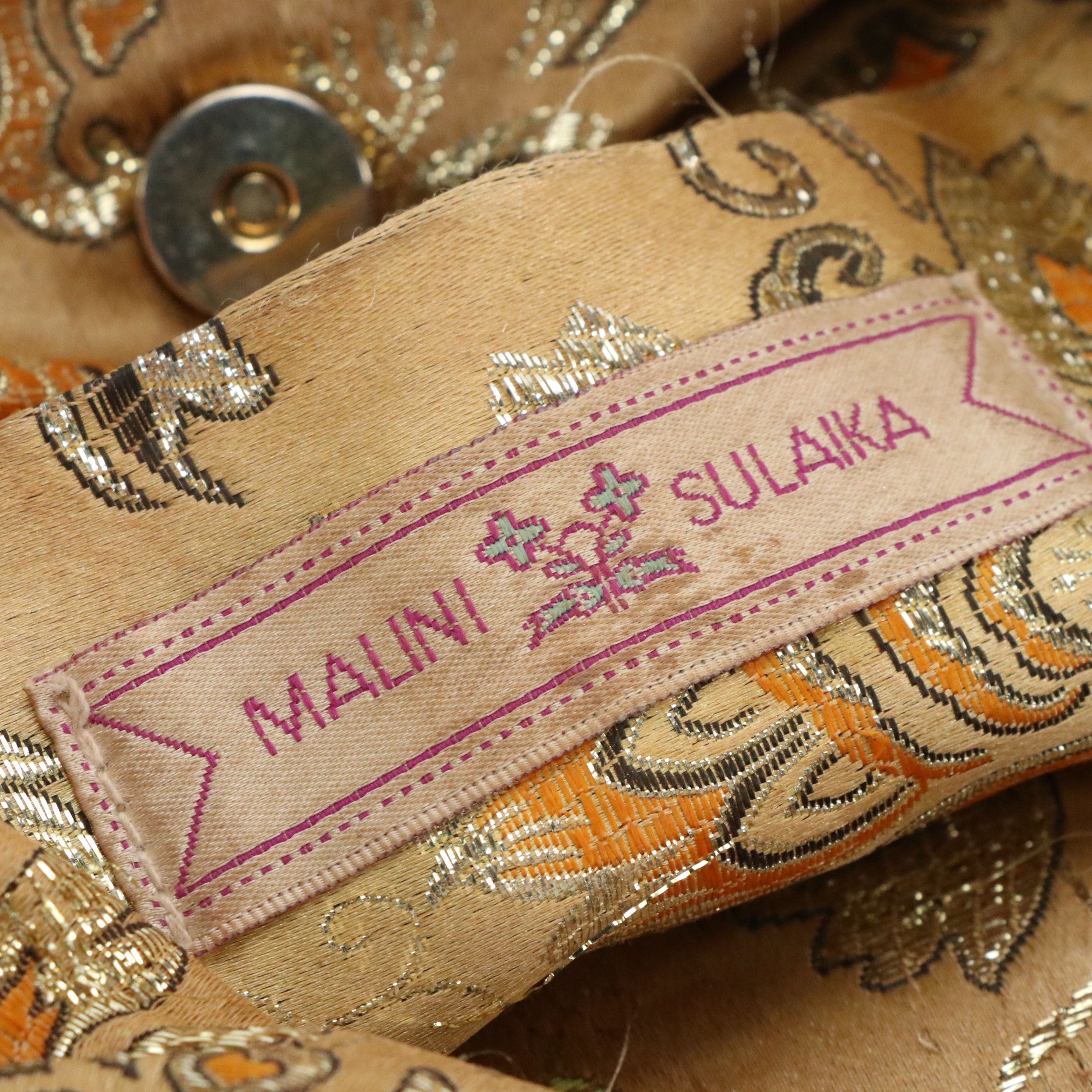 Malini Sulaika Gold Tone Mesh Bag and Thomas Wylde Chain Link Belt