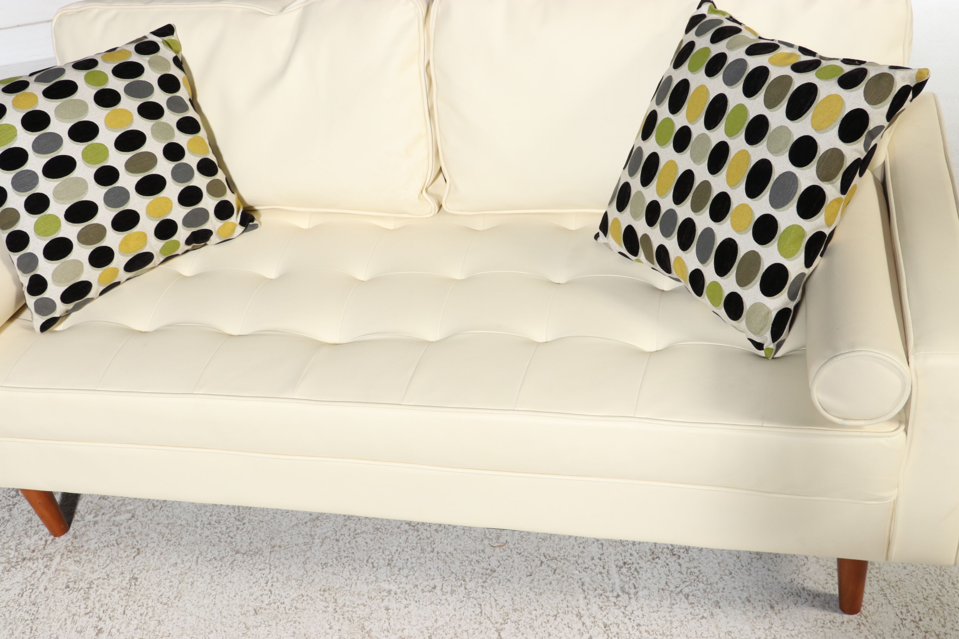 Contemporary Mid Century Modern Style Faux Leather Sofa and Polka Dot Pillows