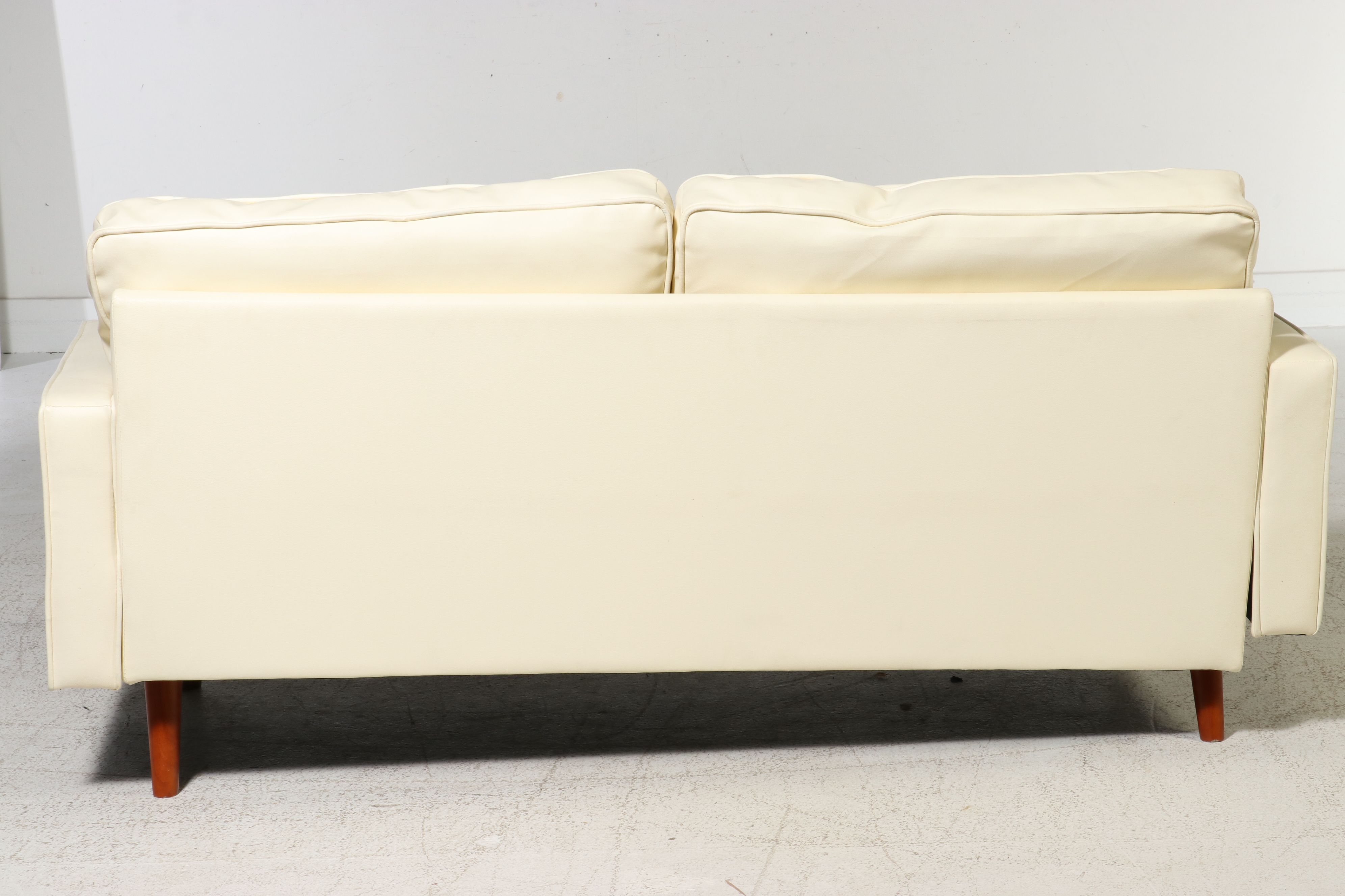 Contemporary Mid Century Modern Style Faux Leather Sofa and Polka Dot Pillows