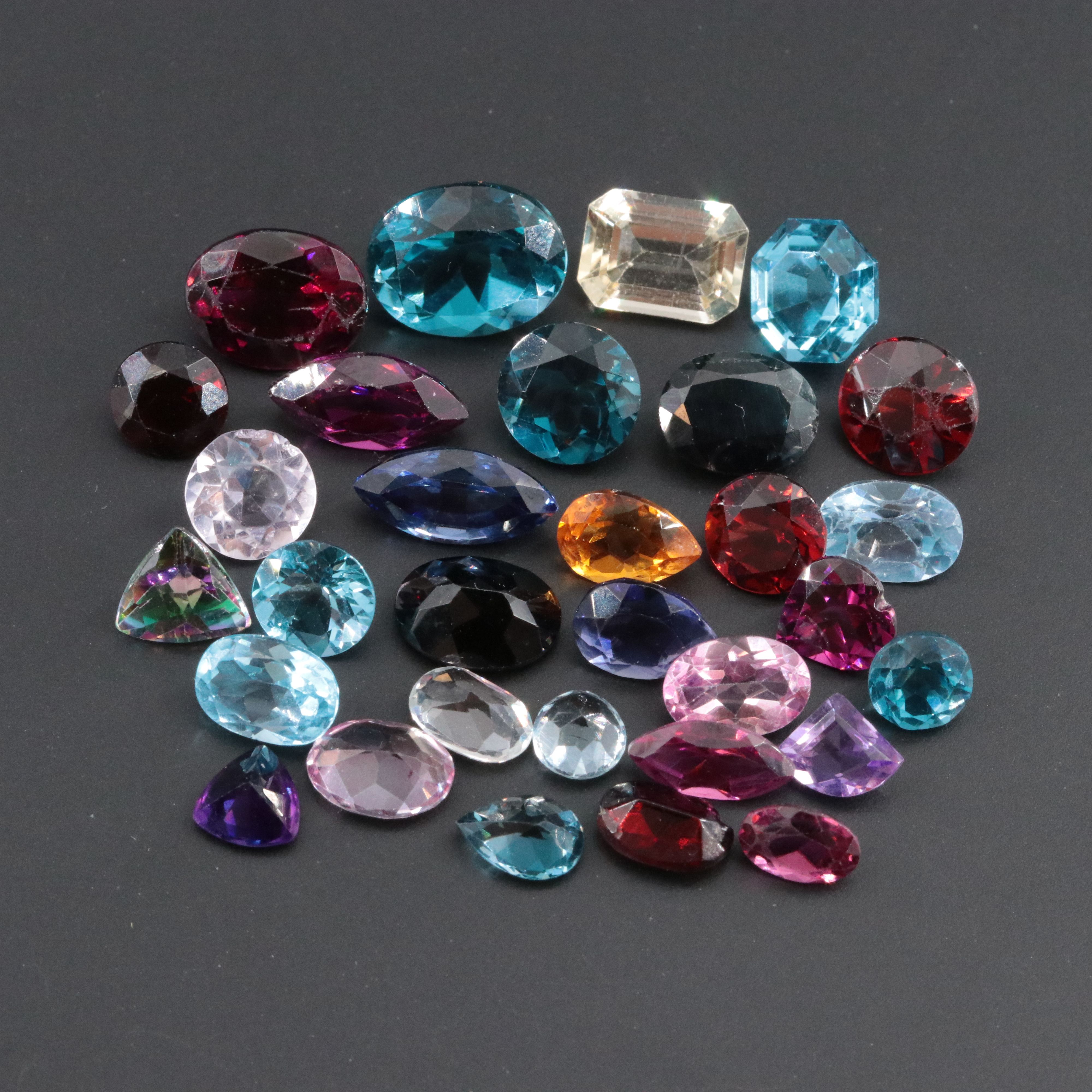 Loose 34.22 CTW Gemstone Lot Featuring Topaz, Citrine, Garnet