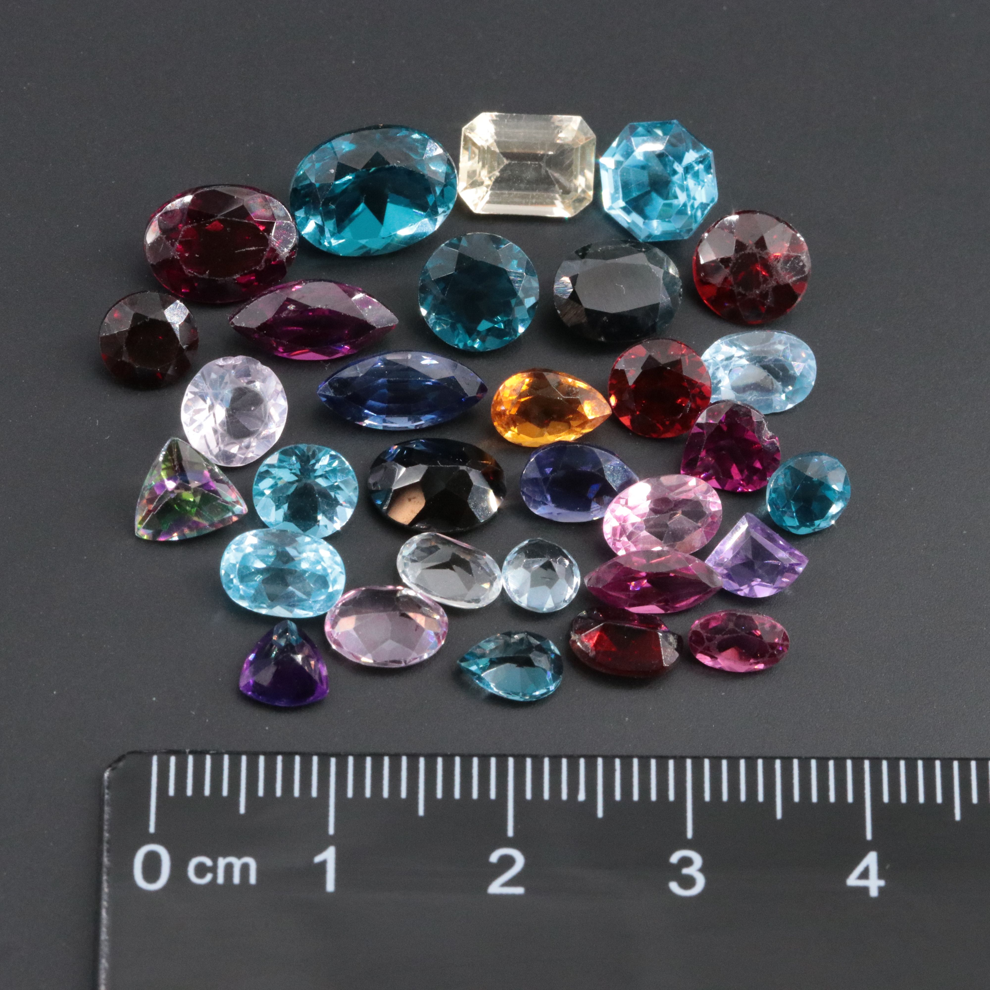 Loose 34.22 CTW Gemstone Lot Featuring Topaz, Citrine, Garnet