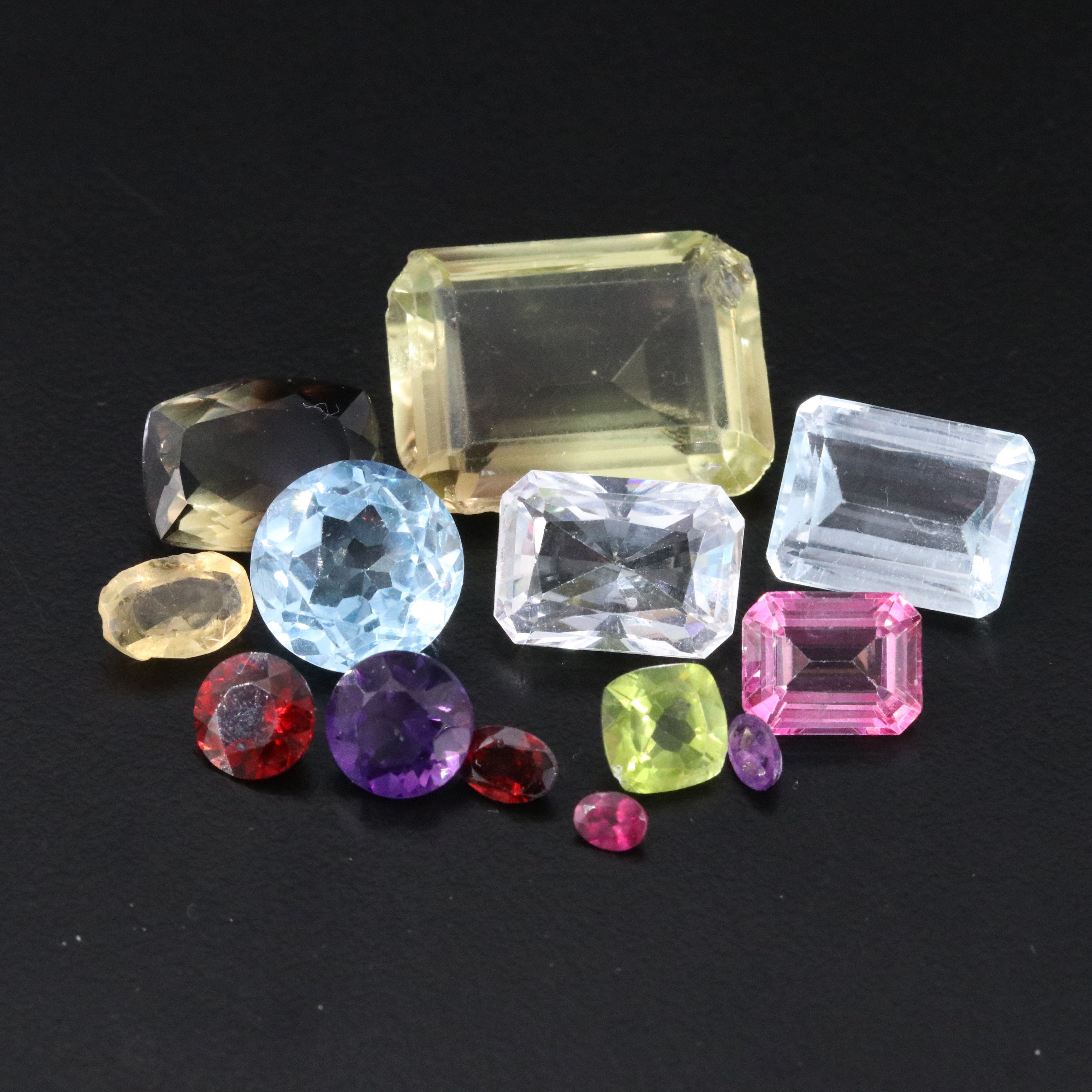 Loose 66.88 CTW Mixed Gemstone Lot Featuring Amethyst, Blue Topaz, and Citrine