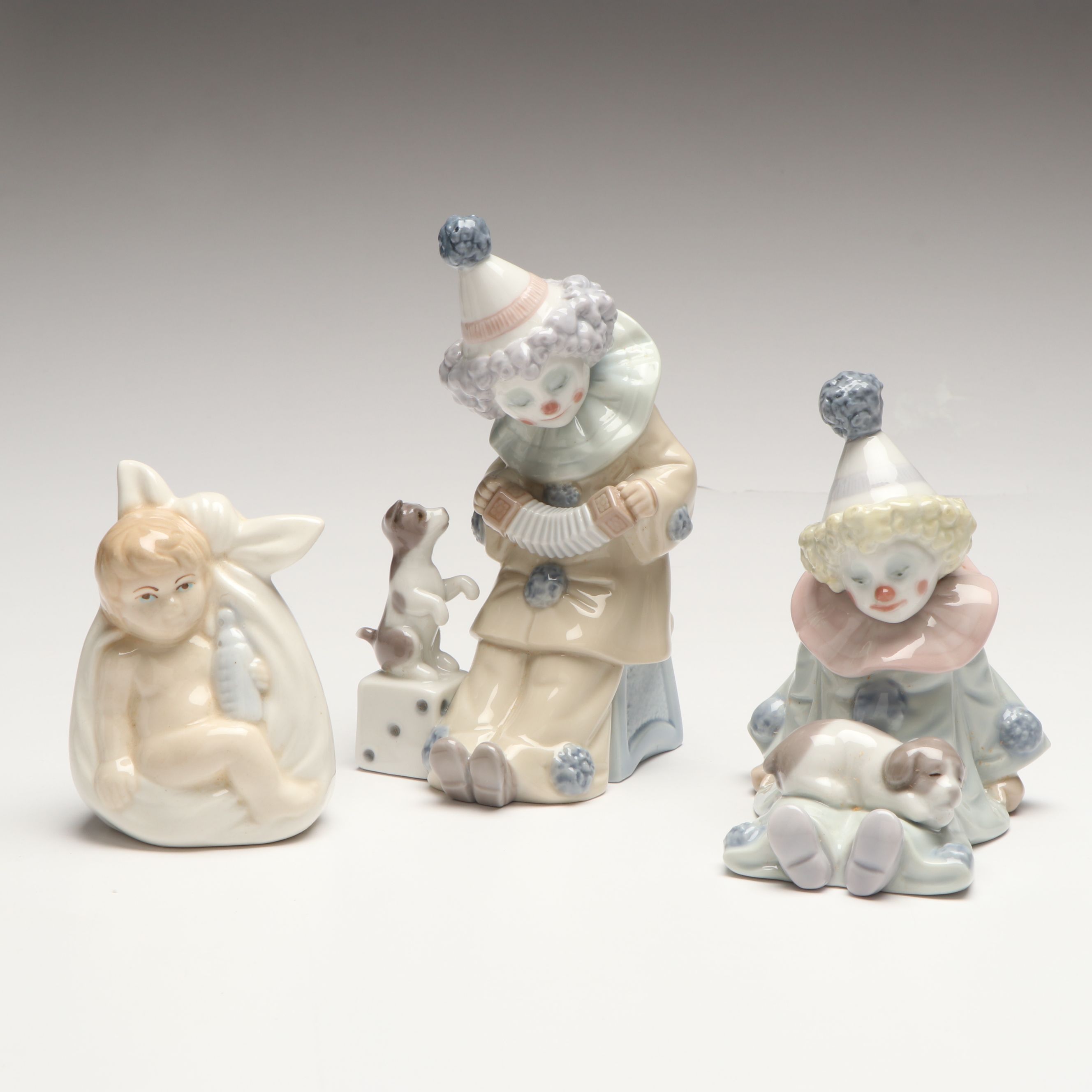 Lladró Clown with Puppy Porcelain Figures and Other Swaddled Baby Figure