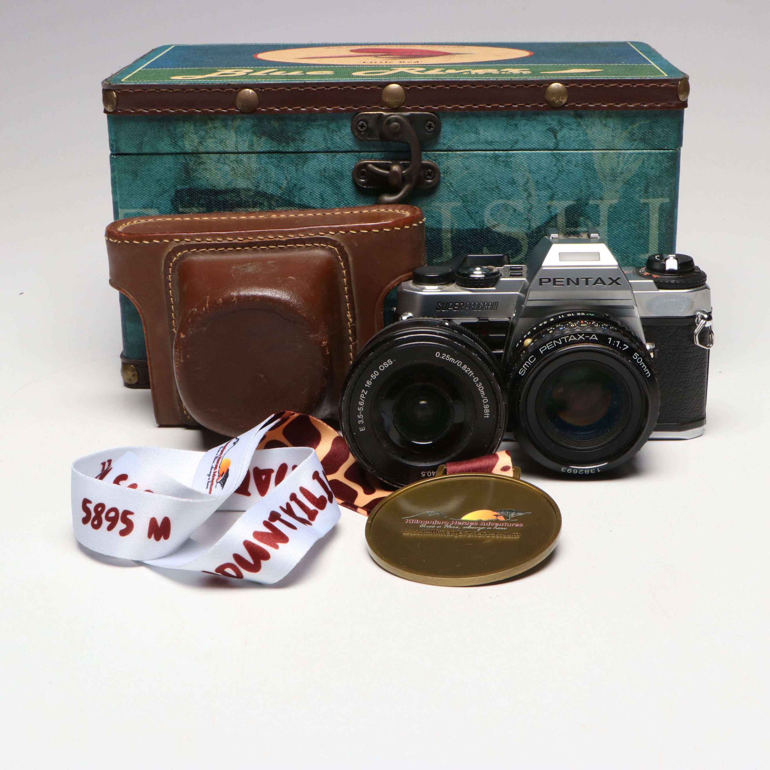 Pentax Super Program Camera and Mt. Kilimanjaro Medal in Blue River Fly Shop Box