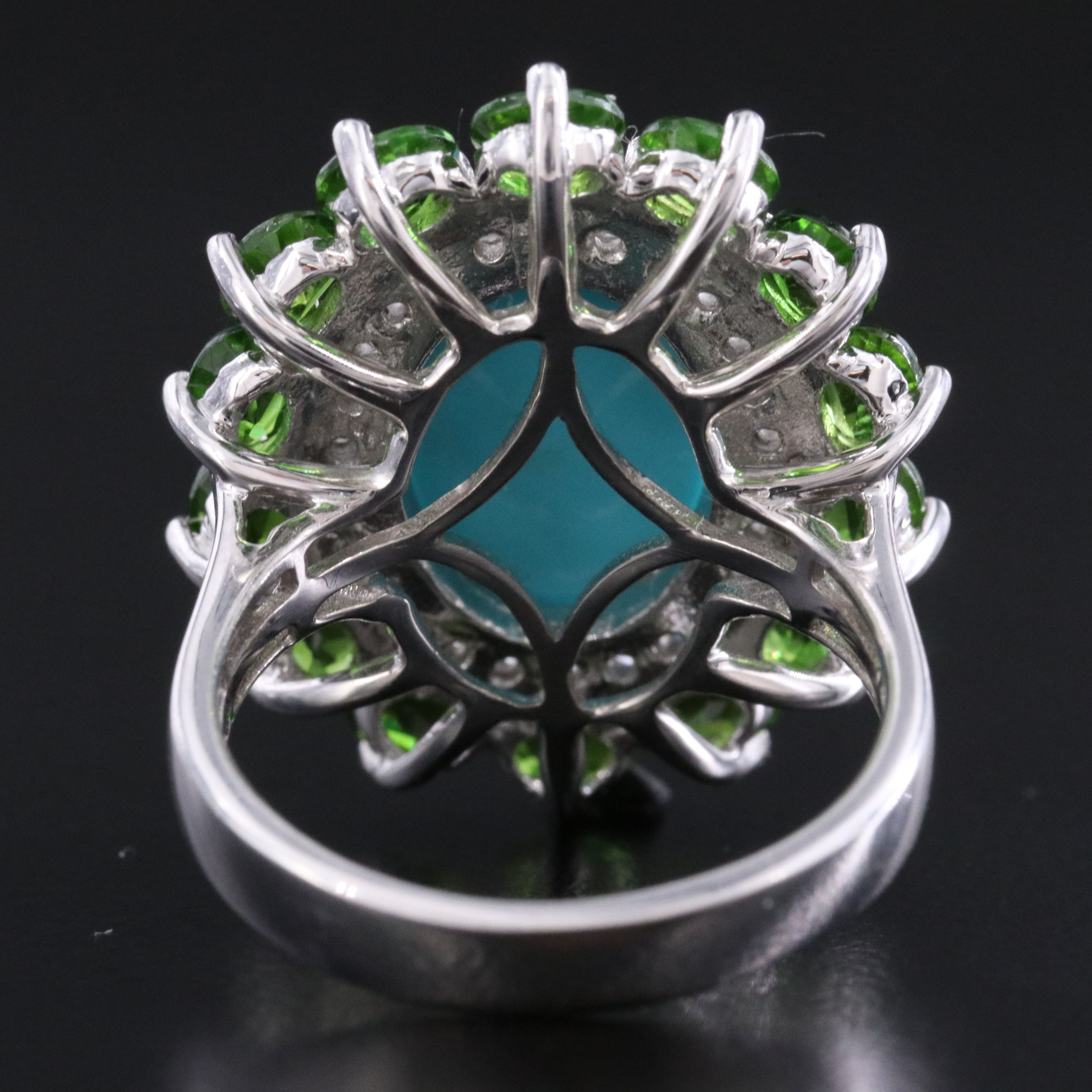 Sterling Turquoise, White Topaz, and Garnet Halo Ring