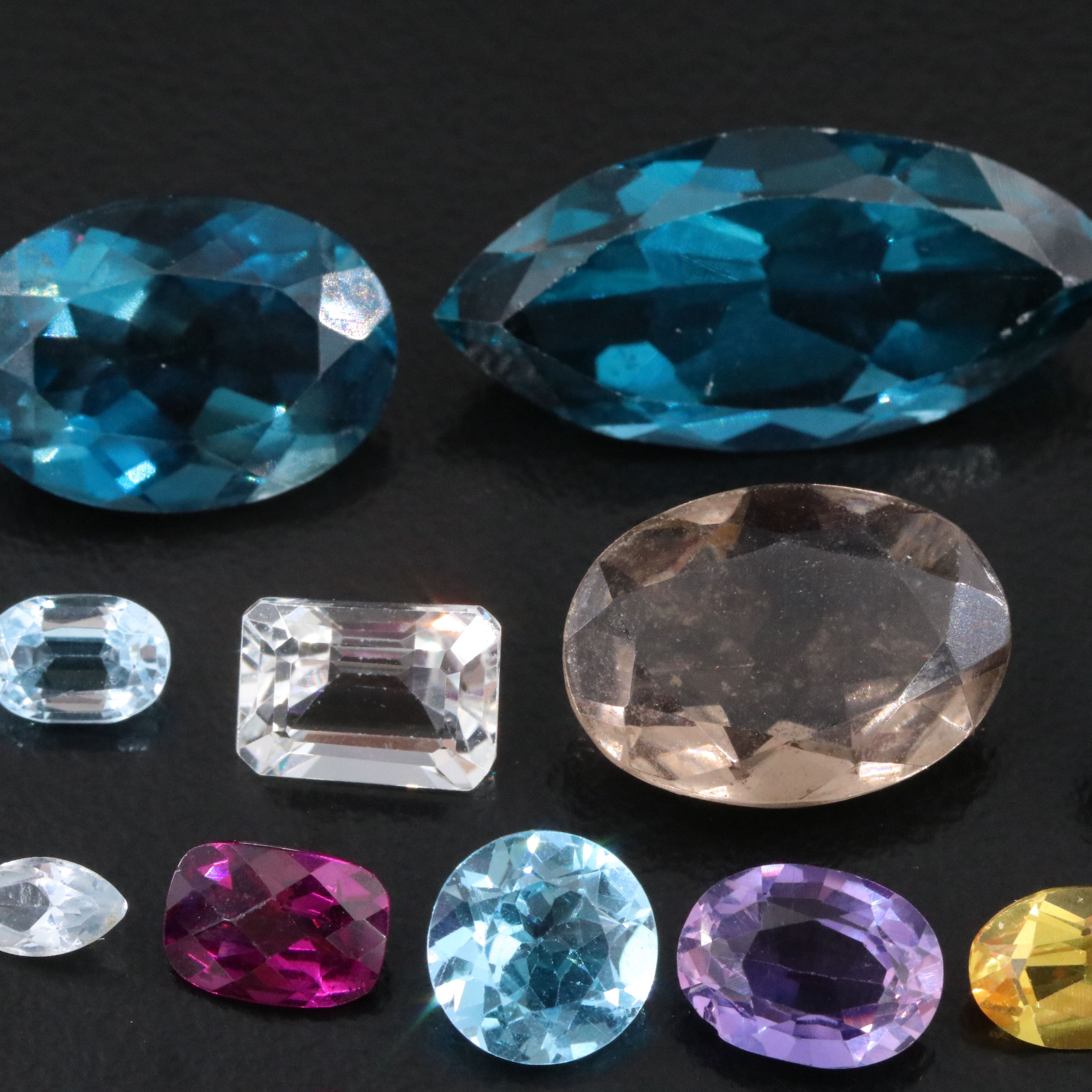 Loose 46.04 CTW Gemstone Lot Including Topaz, Garnet and Lab Grown Sapphire