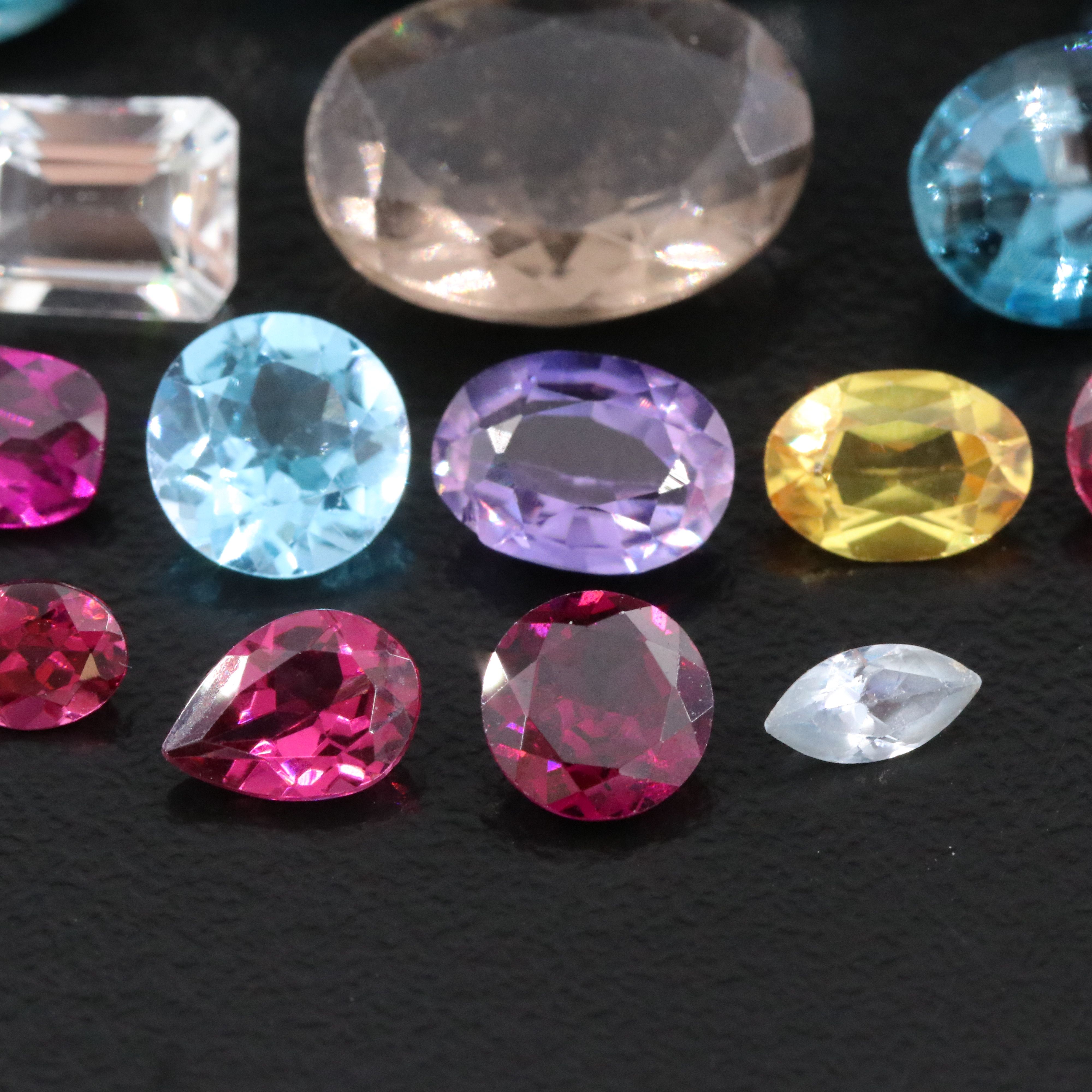 Loose 46.04 CTW Gemstone Lot Including Topaz, Garnet and Lab Grown Sapphire