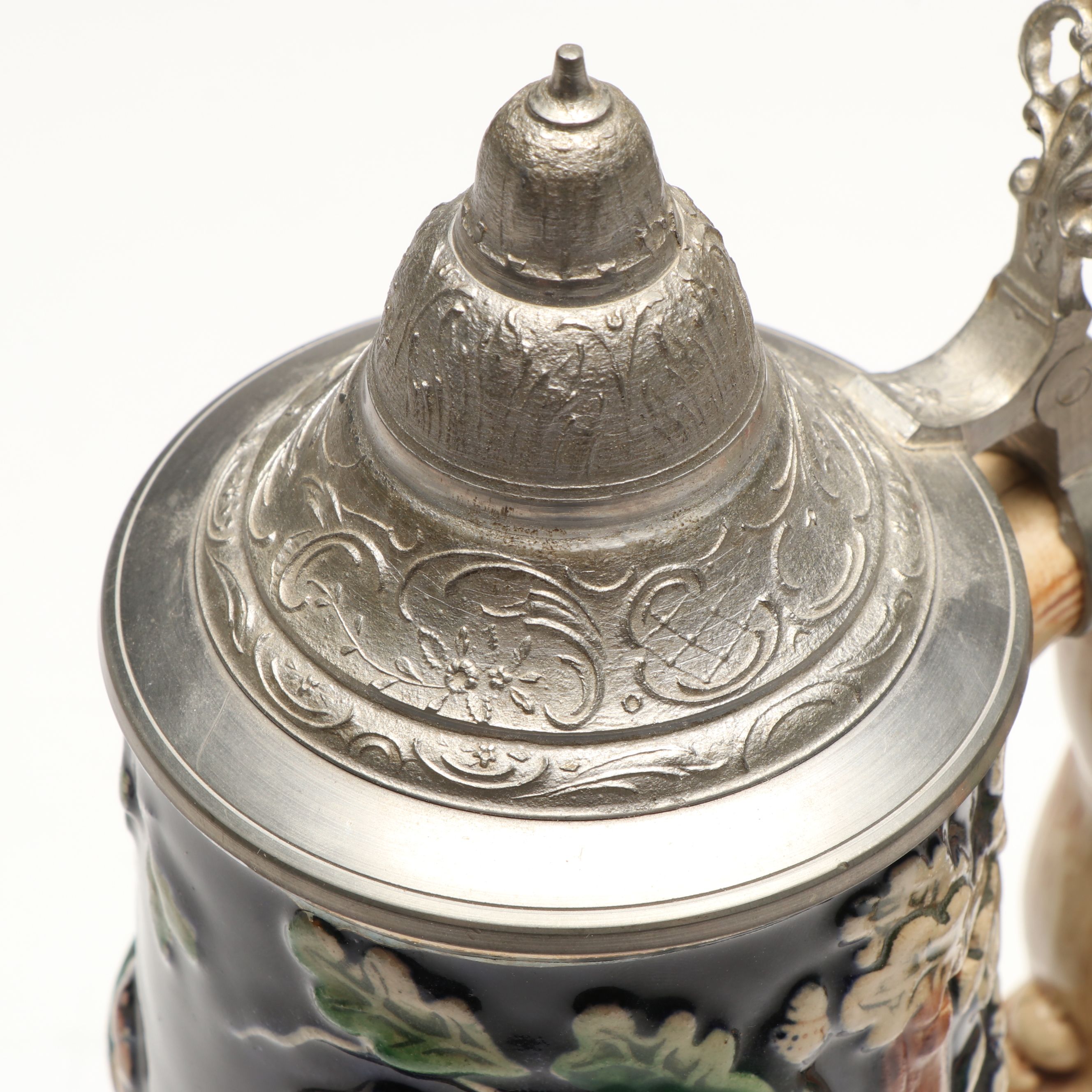 Pair of German Embossed Provincial Scene Steins