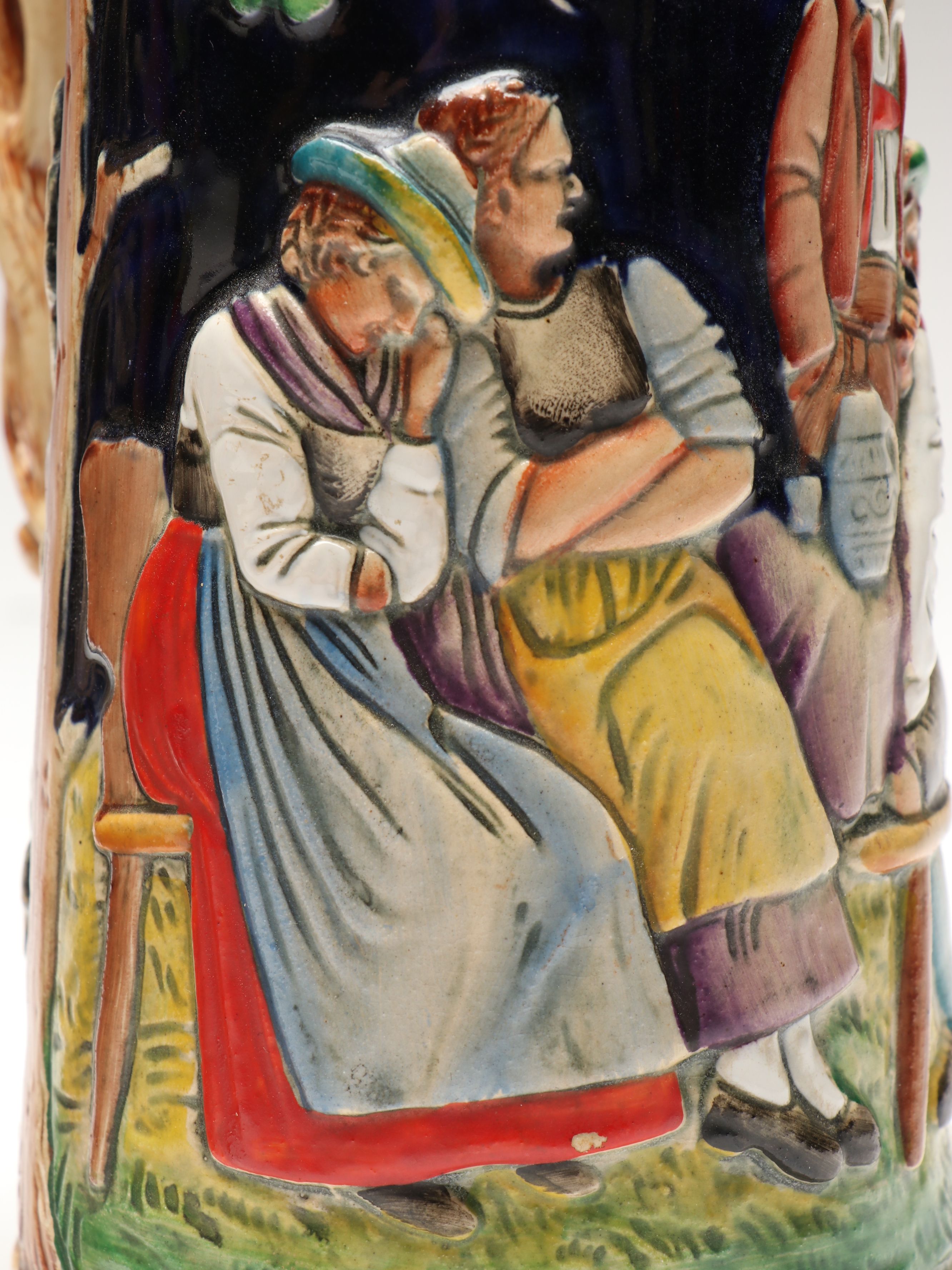 Pair of German Embossed Provincial Scene Steins