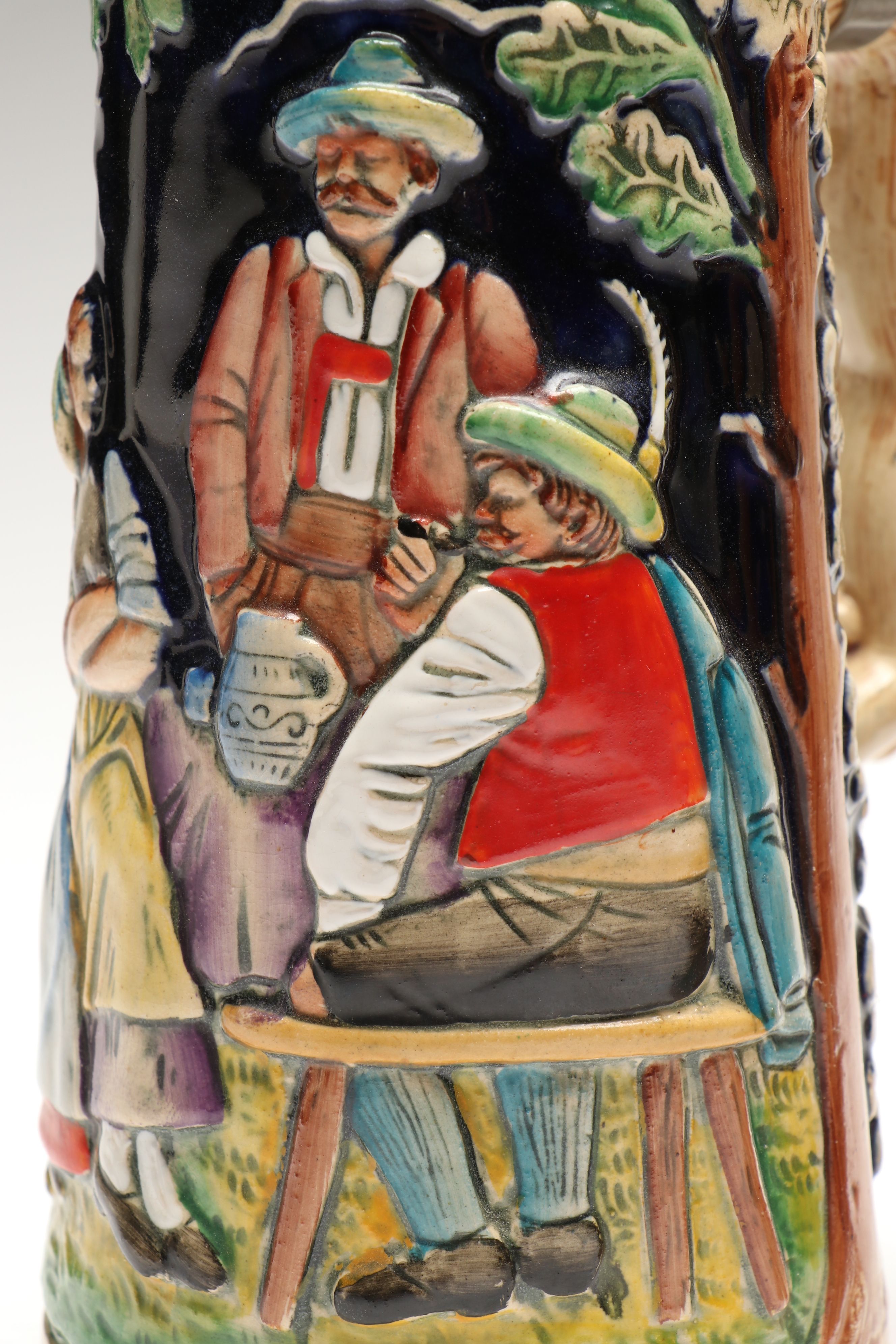 Pair of German Embossed Provincial Scene Steins