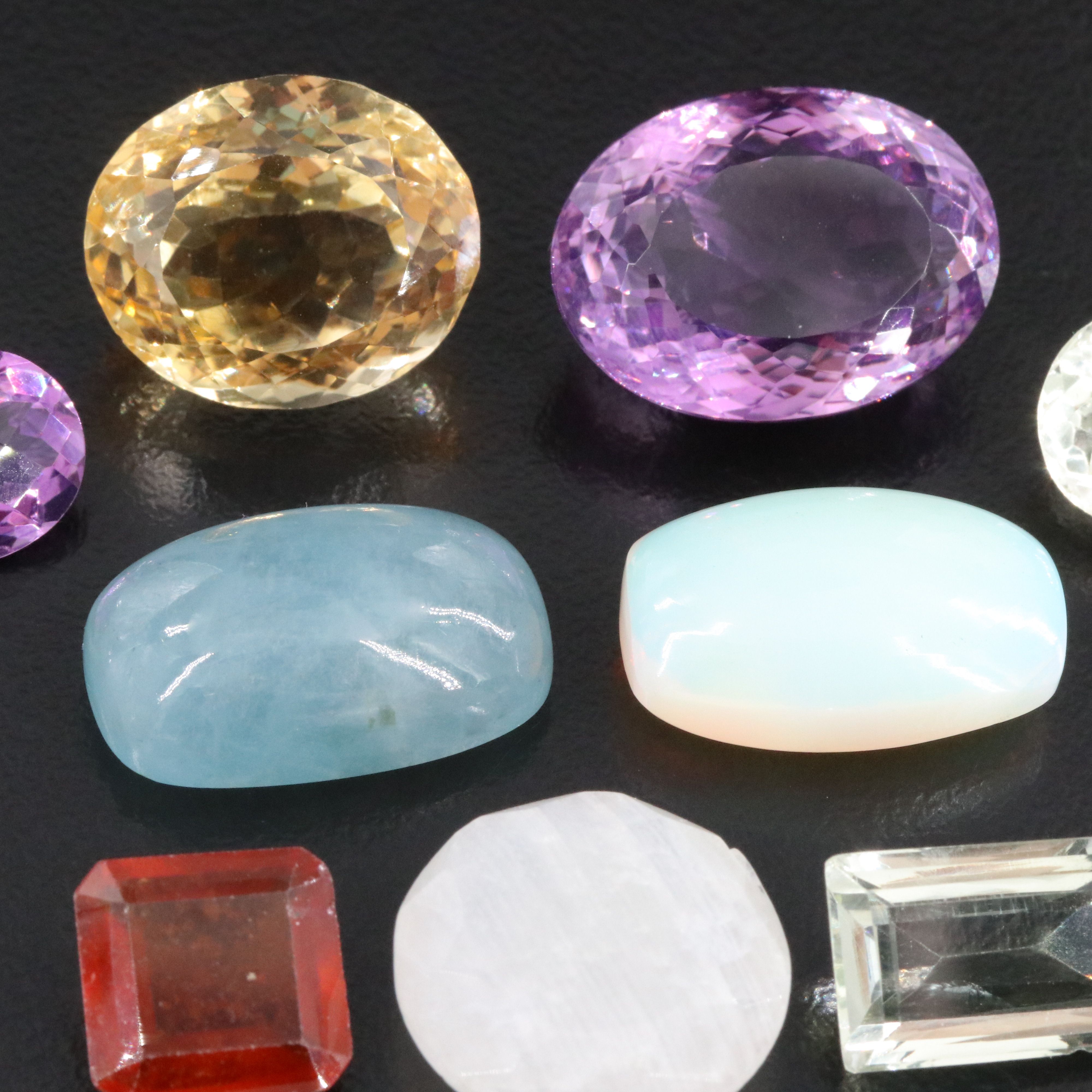 Loose 99.38 CTW Gemstone Lot Including Amethyst, Citrine and Hessonite Garnet