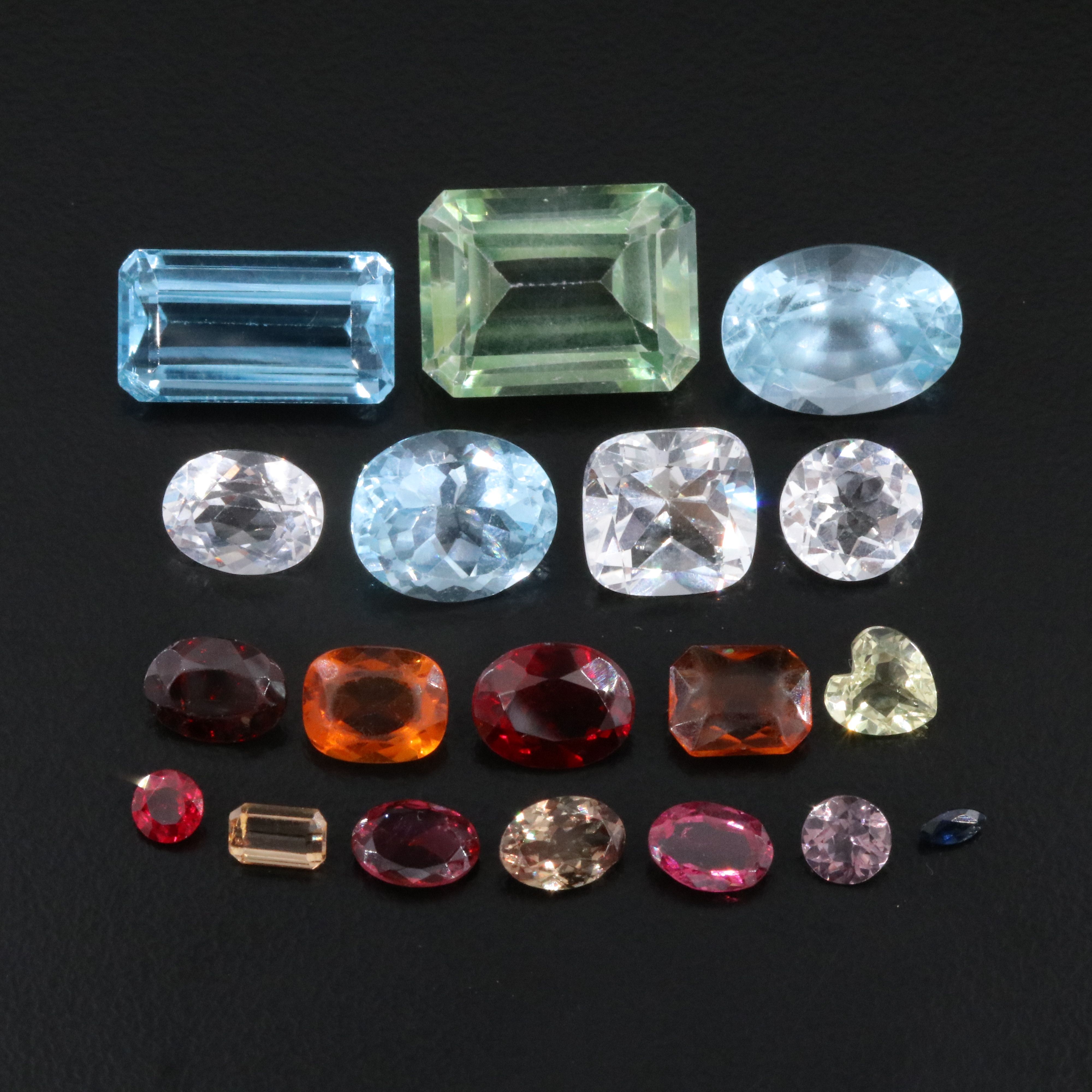 Loose 58.40 CTW Gemstone Lot Including Topaz, Garnet and Lab Grown Ruby