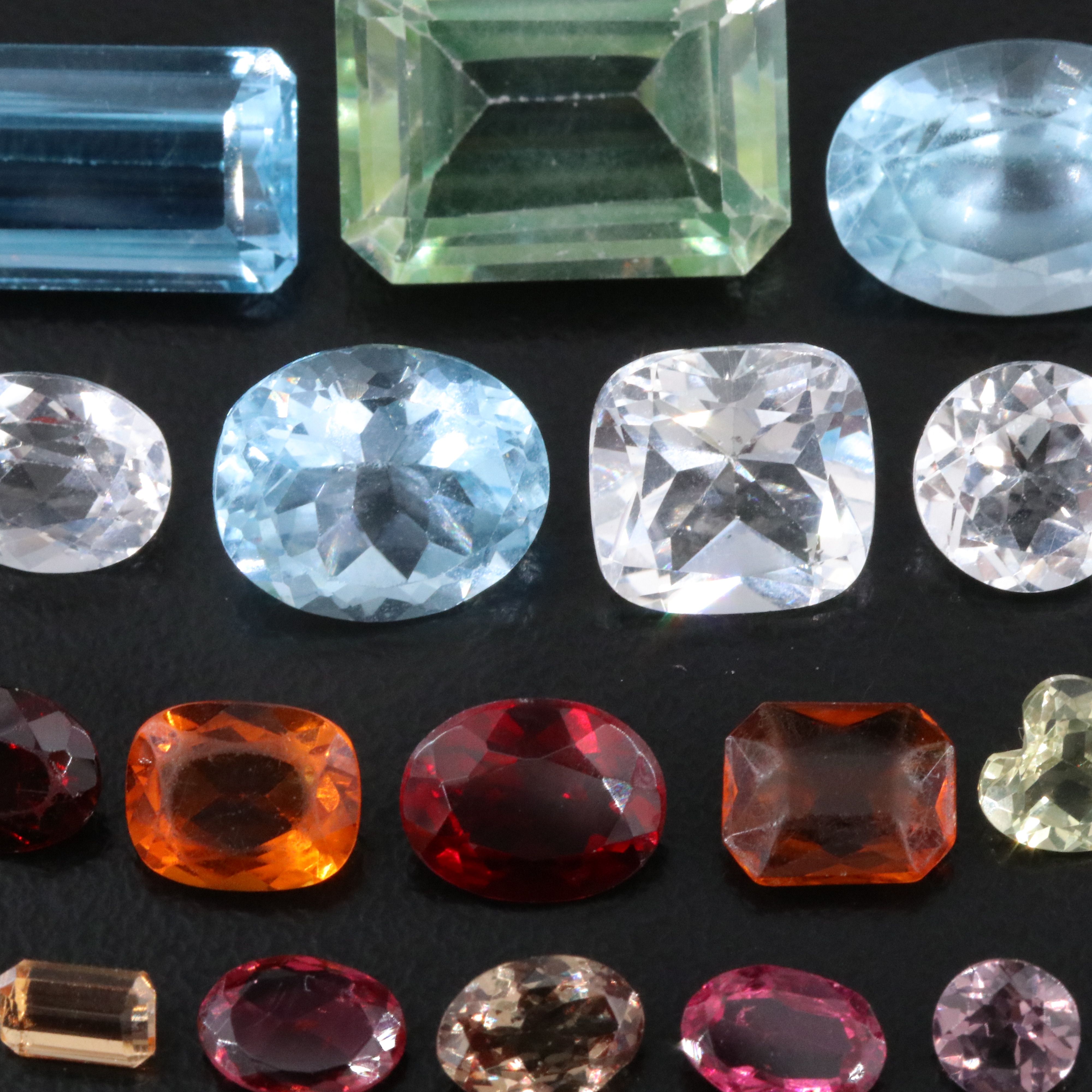 Loose 58.40 CTW Gemstone Lot Including Topaz, Garnet and Lab Grown Ruby