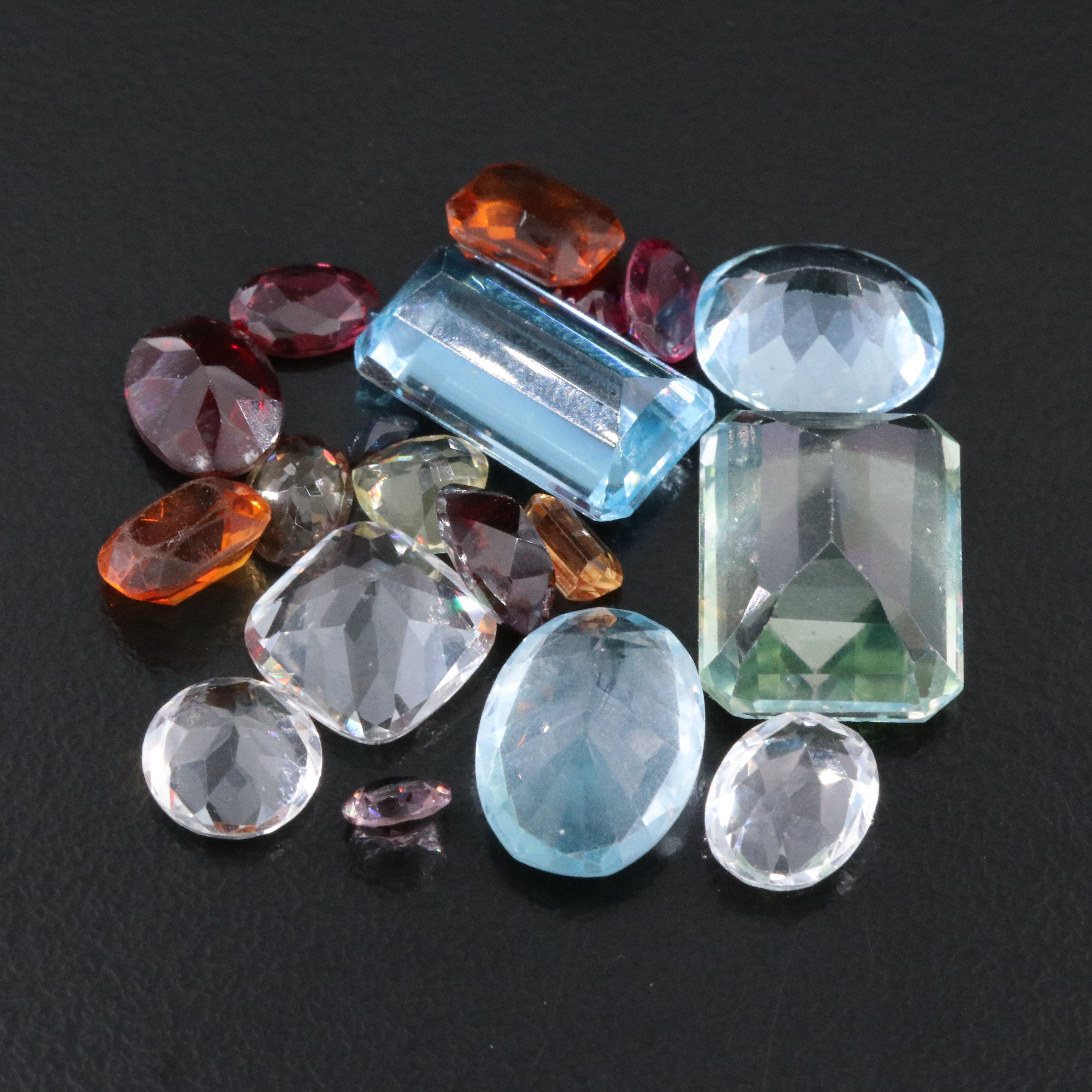 Loose 58.40 CTW Gemstone Lot Including Topaz, Garnet and Lab Grown Ruby