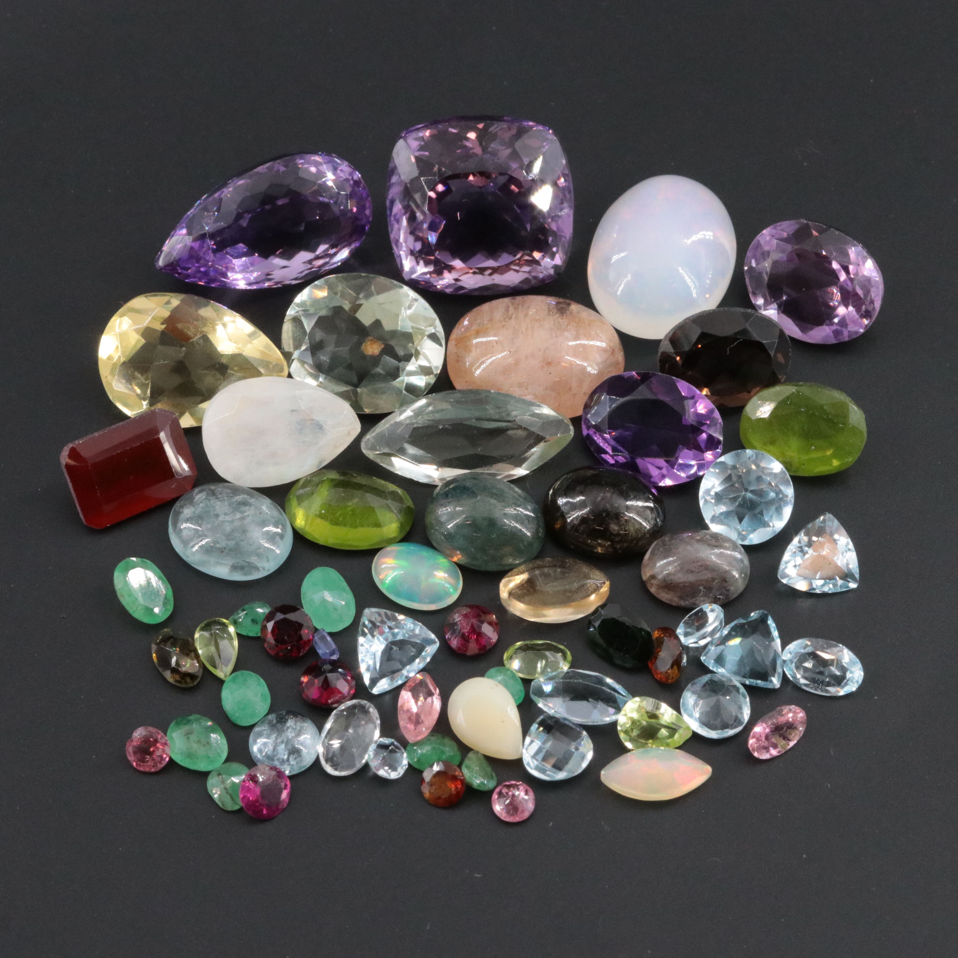 Loose 90.24 CTW Gemstone Lot Including Rainbow Moonstone, Amethyst and Emerald
