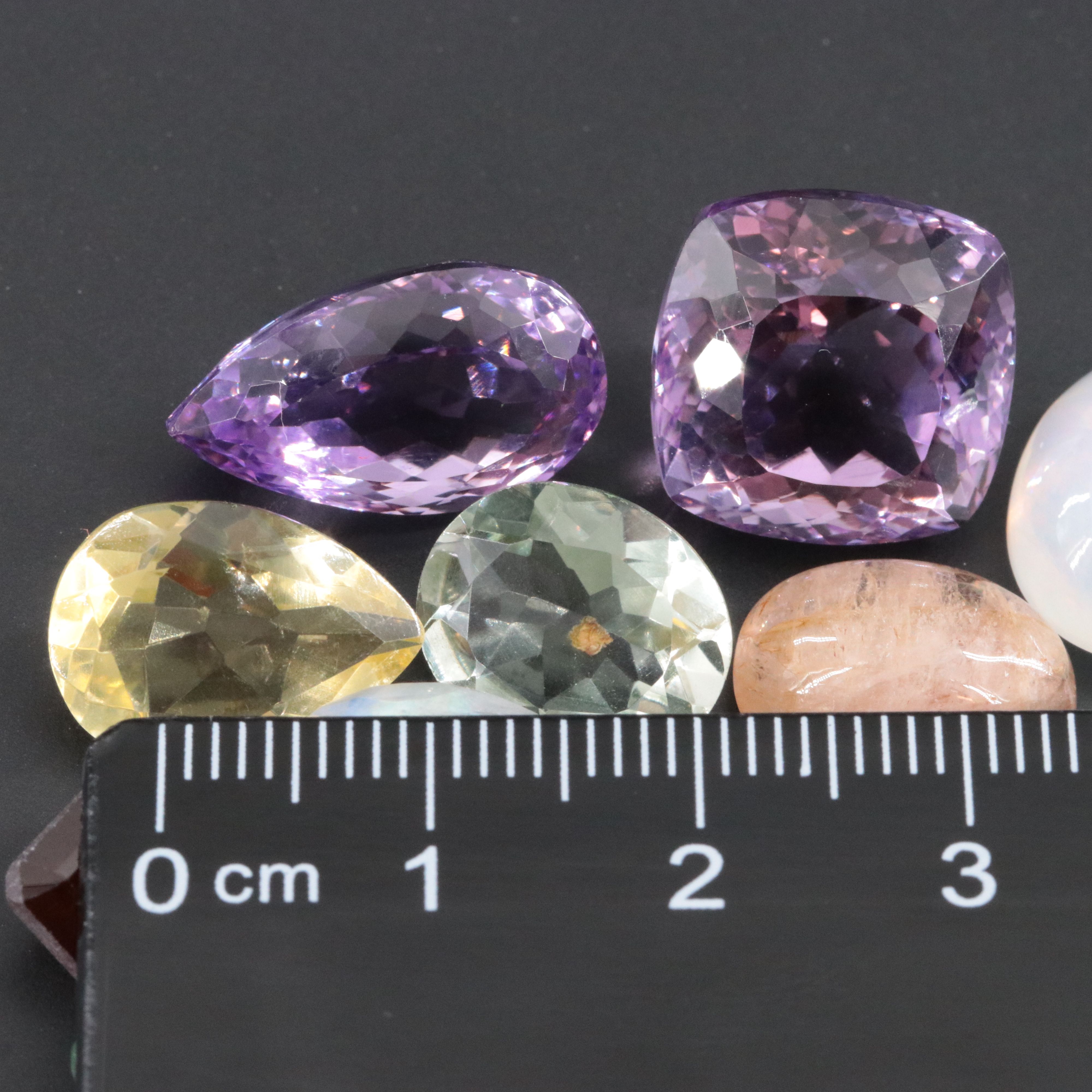 Loose 90.24 CTW Gemstone Lot Including Rainbow Moonstone, Amethyst and Emerald