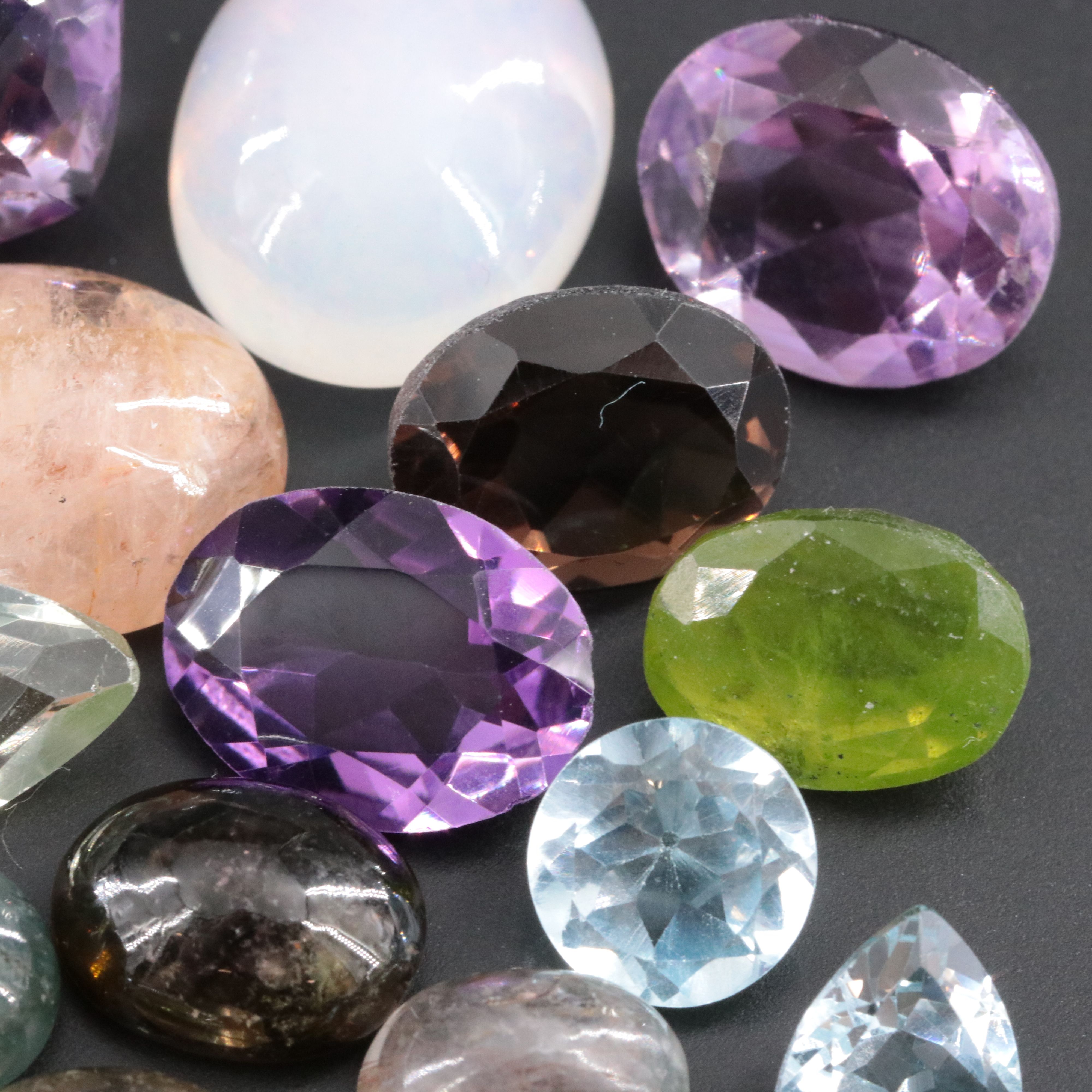 Loose 90.24 CTW Gemstone Lot Including Rainbow Moonstone, Amethyst and Emerald
