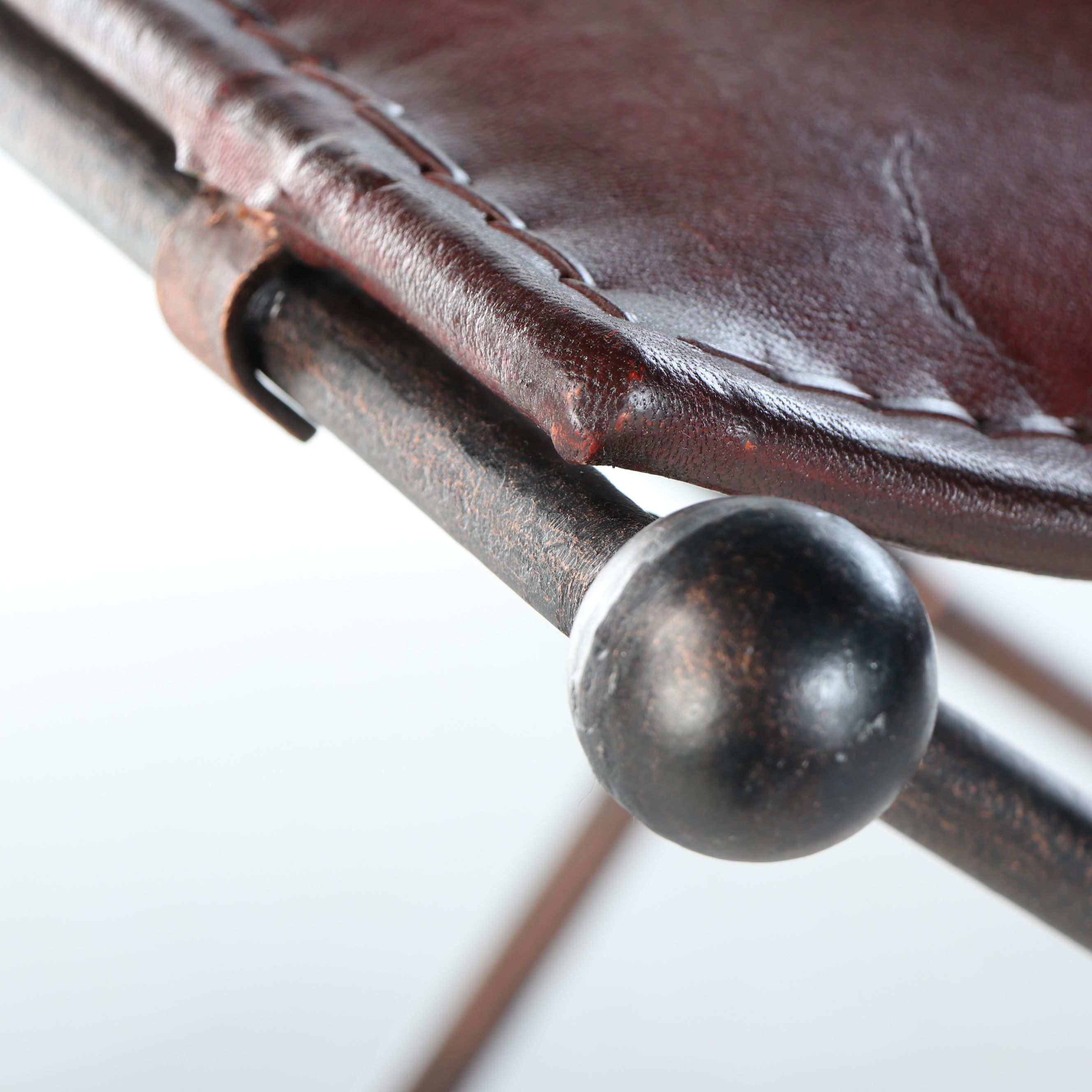 Rustic Padded Leather Footstools with Scrolled Folding Metal Frames