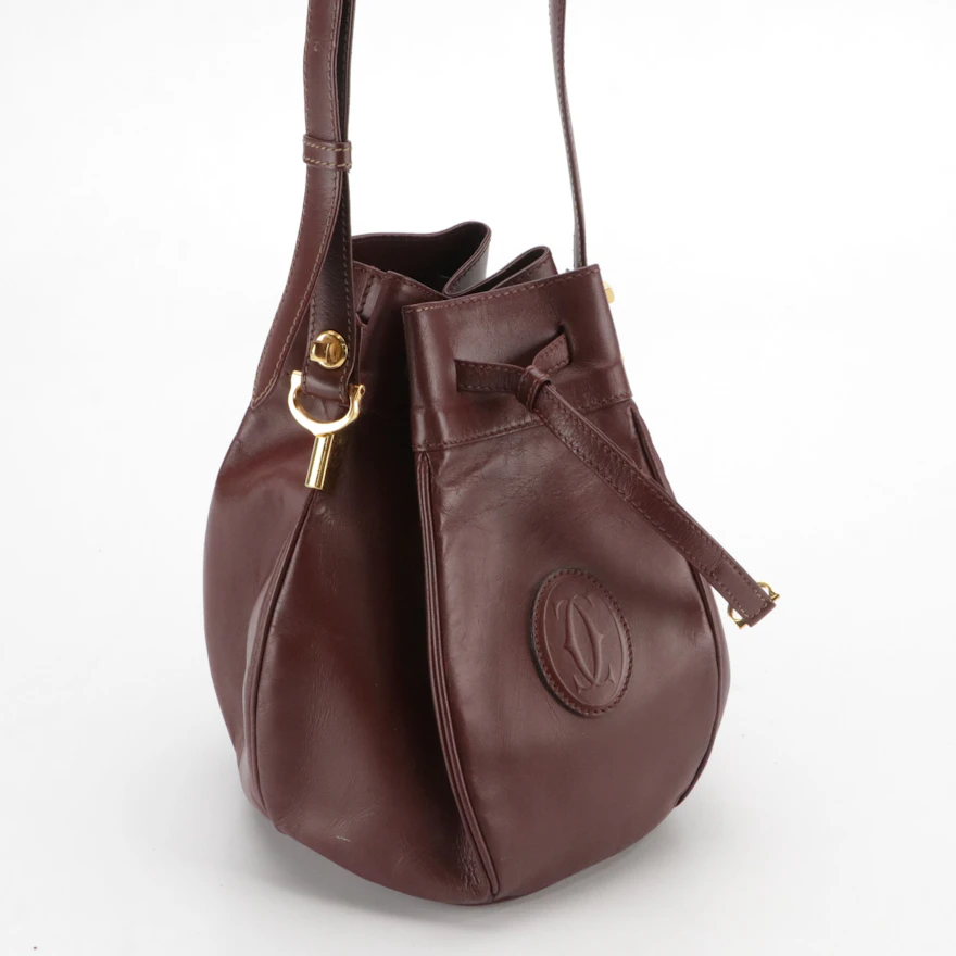 Cartier Must de Cartier Small Drawstring Bucket Bag in Burgundy Leather ...