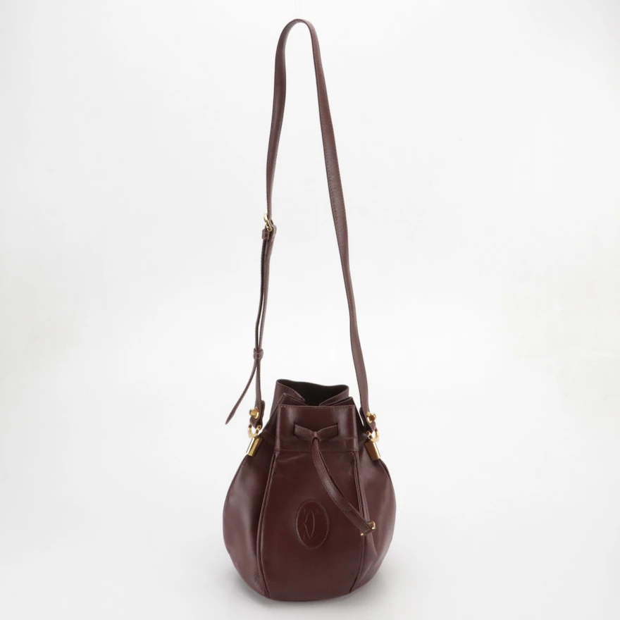 Cartier Must de Cartier Small Drawstring Bucket Bag in Burgundy Leather ...