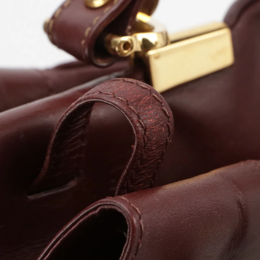 Cartier Must de Cartier Small Drawstring Bucket Bag in Burgundy Leather ...