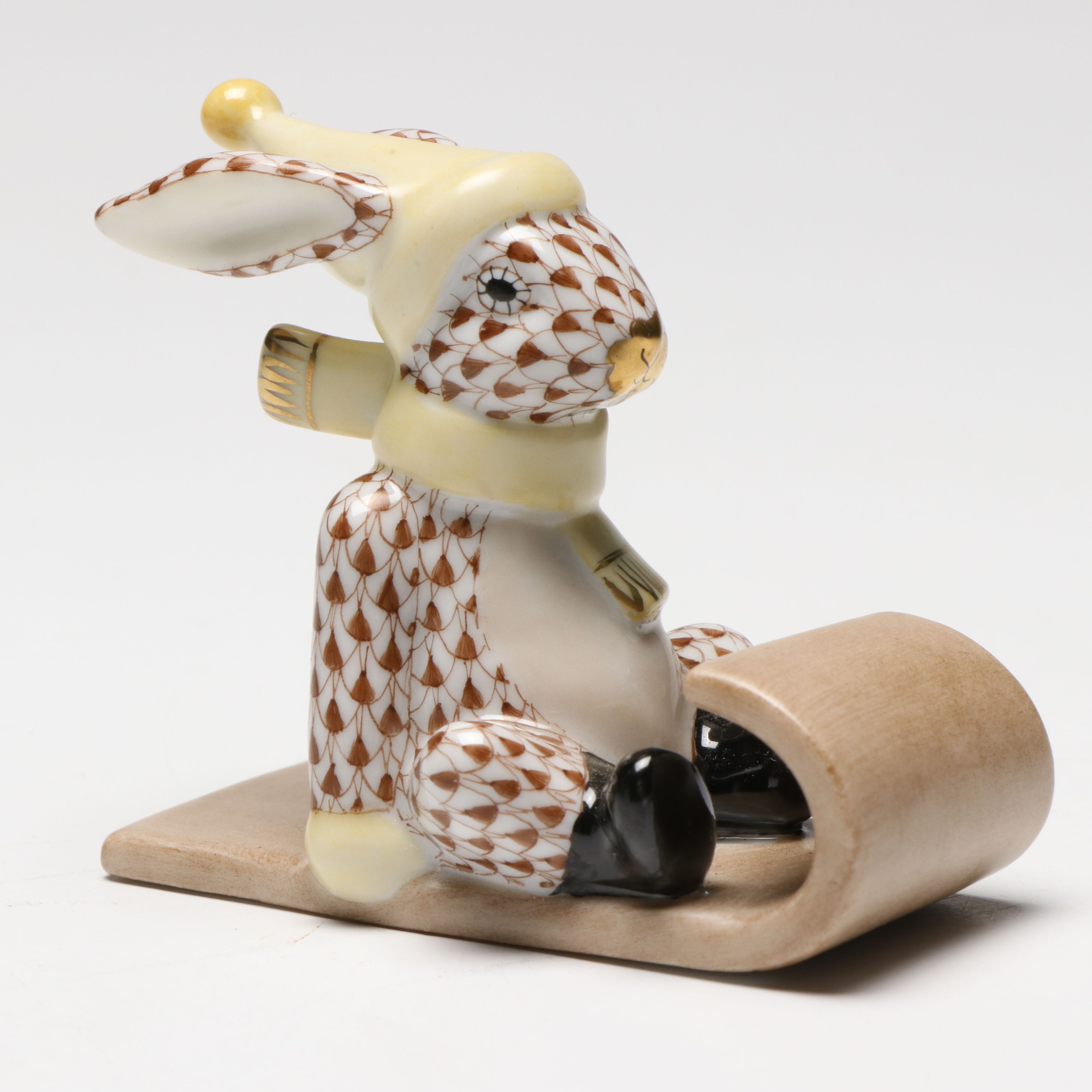 Herend Chocolate Fishnet with Gold "Sledding Bunny" Porcelain Figurine